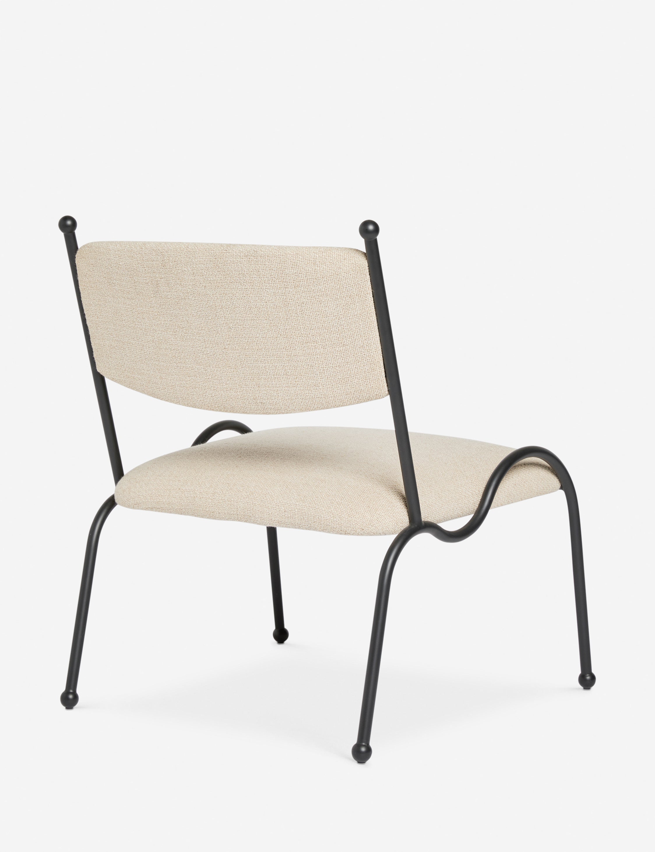 Angled back view of the Fidia curved metal silhouette accent chair by Aimee Song