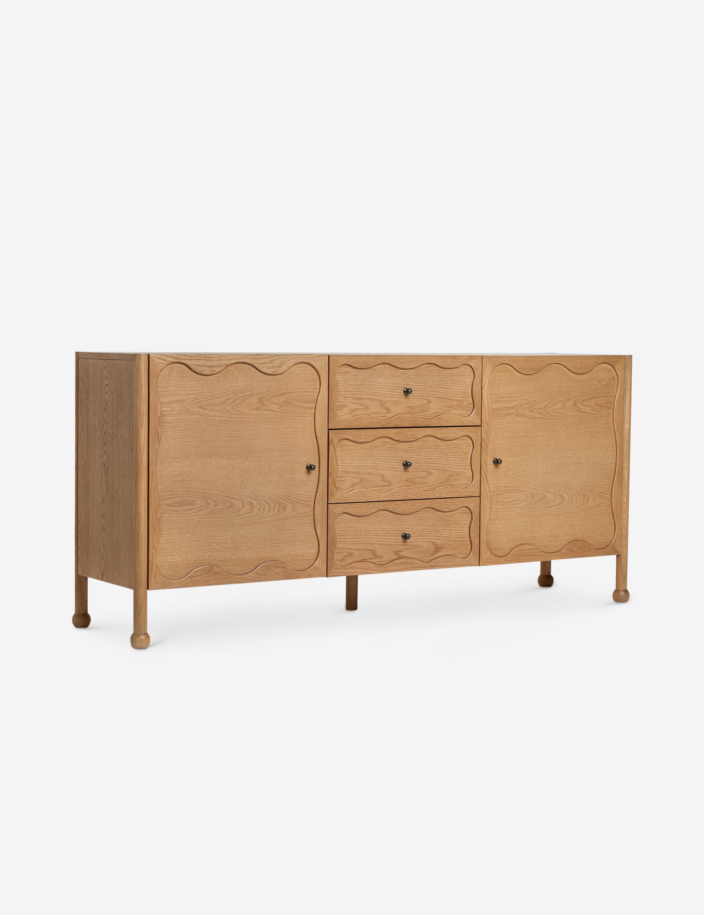 Angled view of the Fontaine wavy detailing solid oak sideboard by Aimee Song