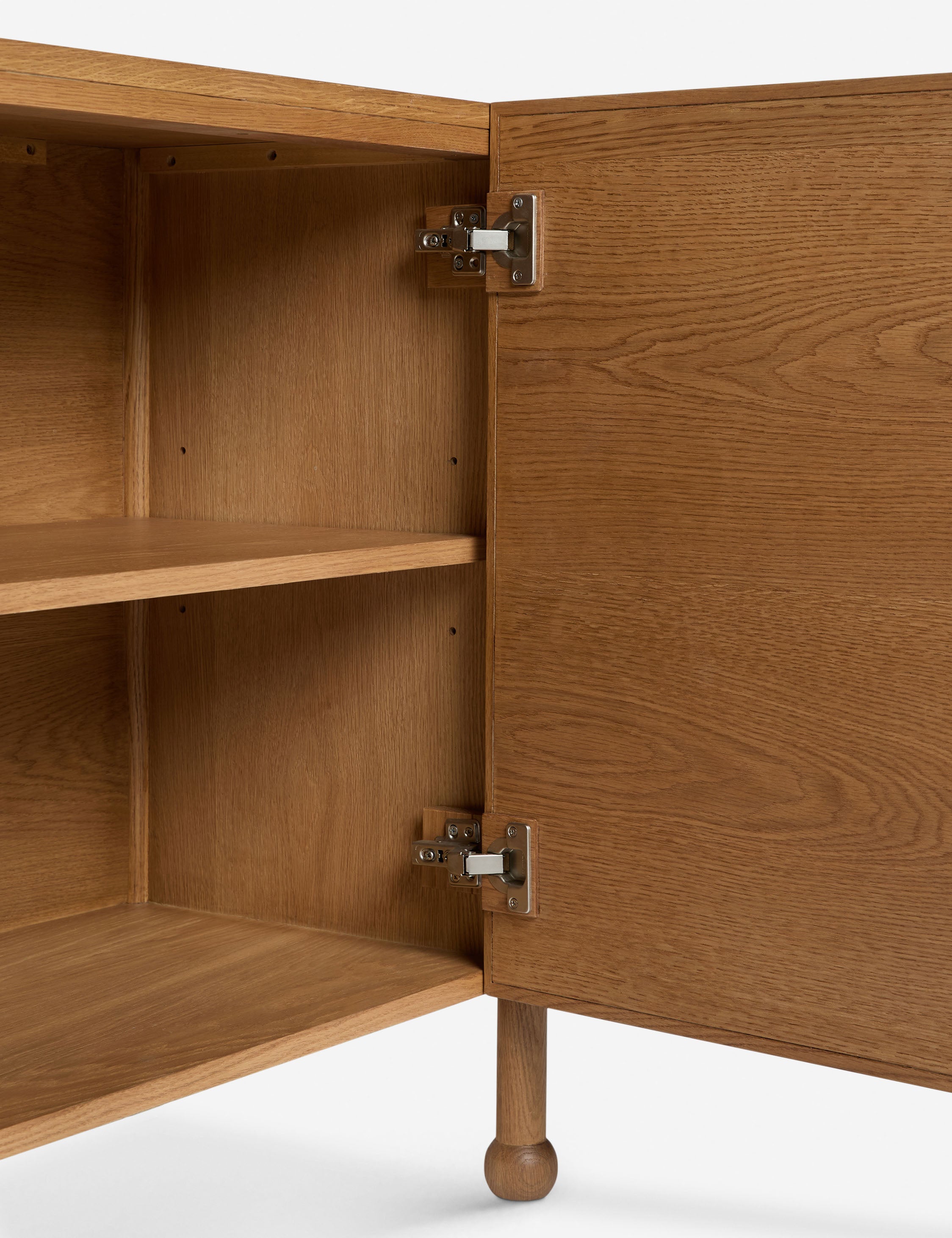 Close up view of the open door of the Fontaine wavy detailing solid oak sideboard by Aimee Song