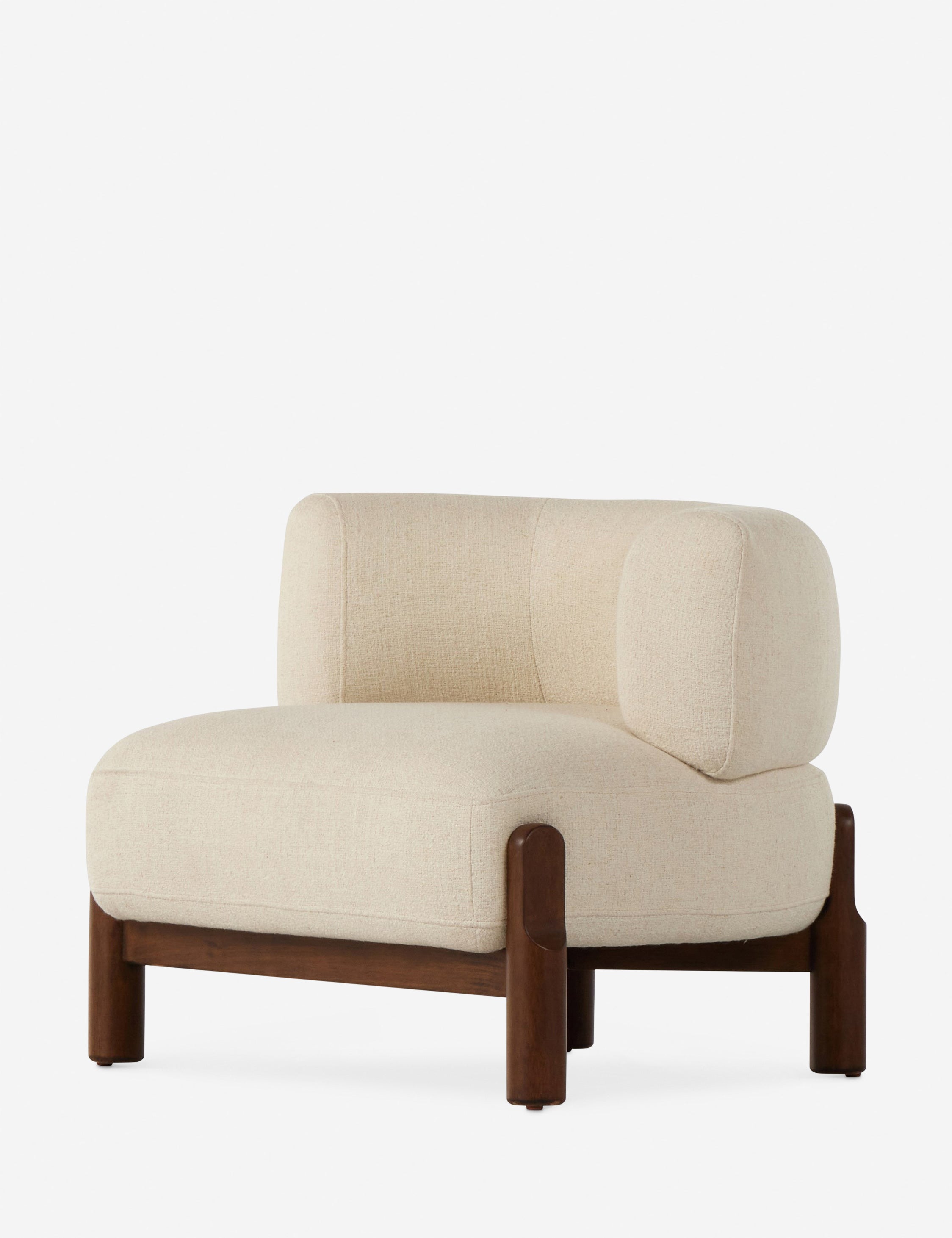 Angled view of the Furst sculptural upholstered barrel back accent chair in ivory.