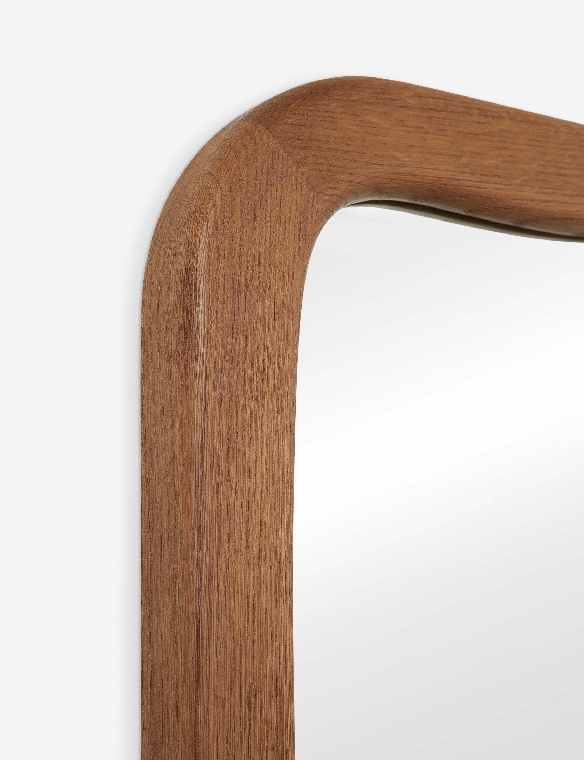 Close up view of the frame of the Galilea solid wavy wood frame mirror mirror by Aimee Song