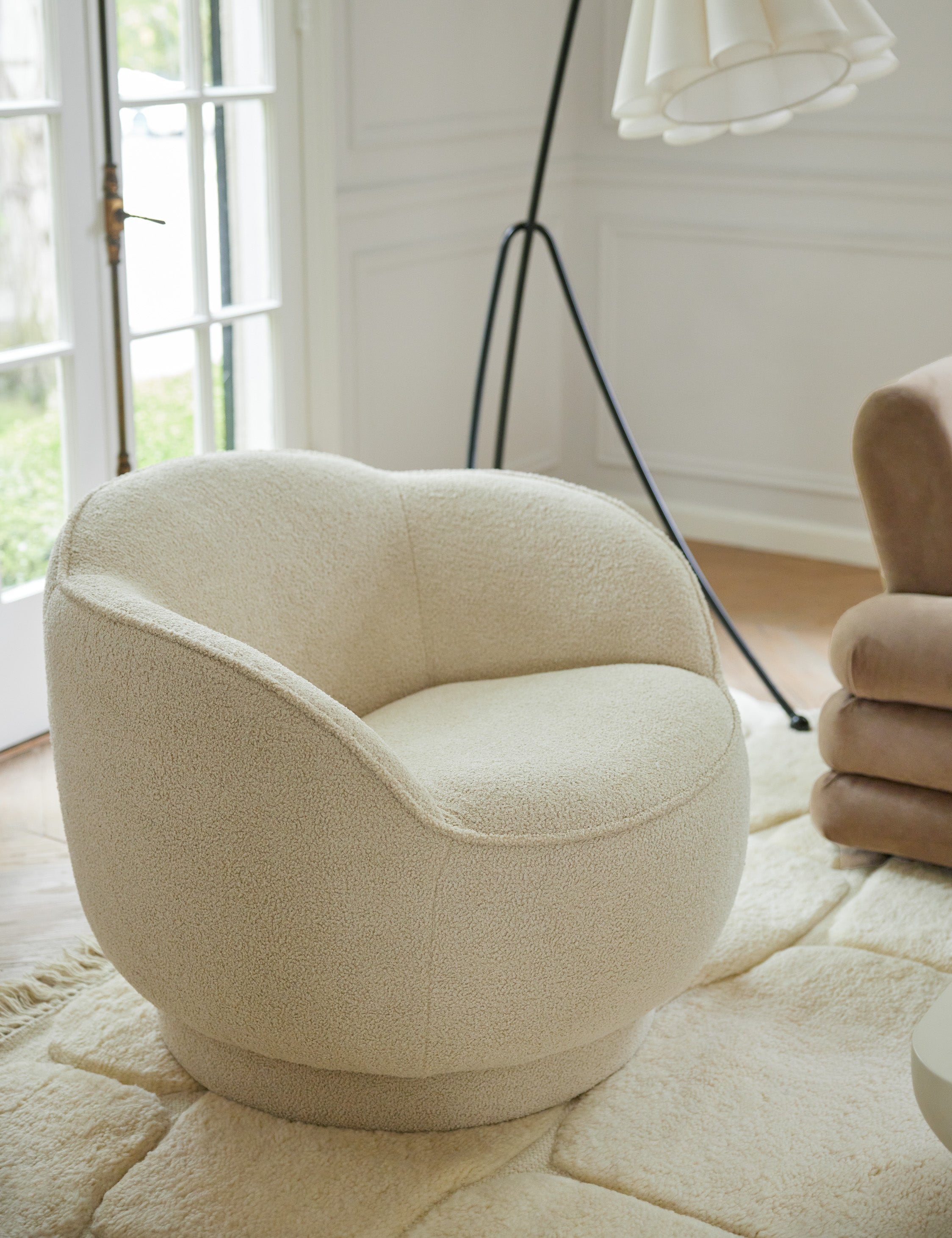 Fern scalloped back boucle upholstered swivel chair styled next to the Addie floor lamp