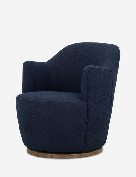 #color::navy | Angled side view of Margie rounded barrel swivel accent chair in navy