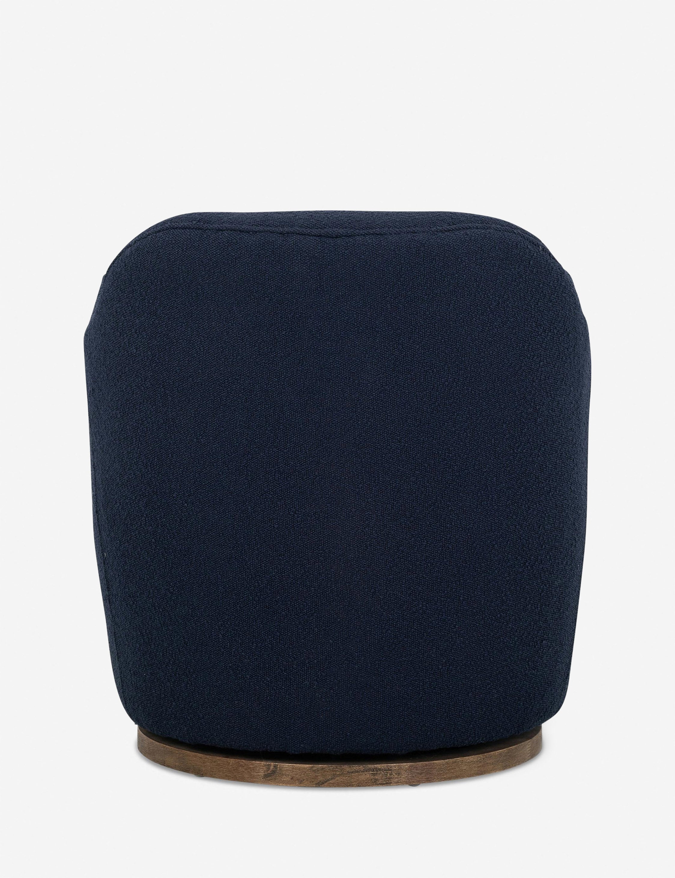 Rear view of Margie rounded barrel swivel accent chair in navy