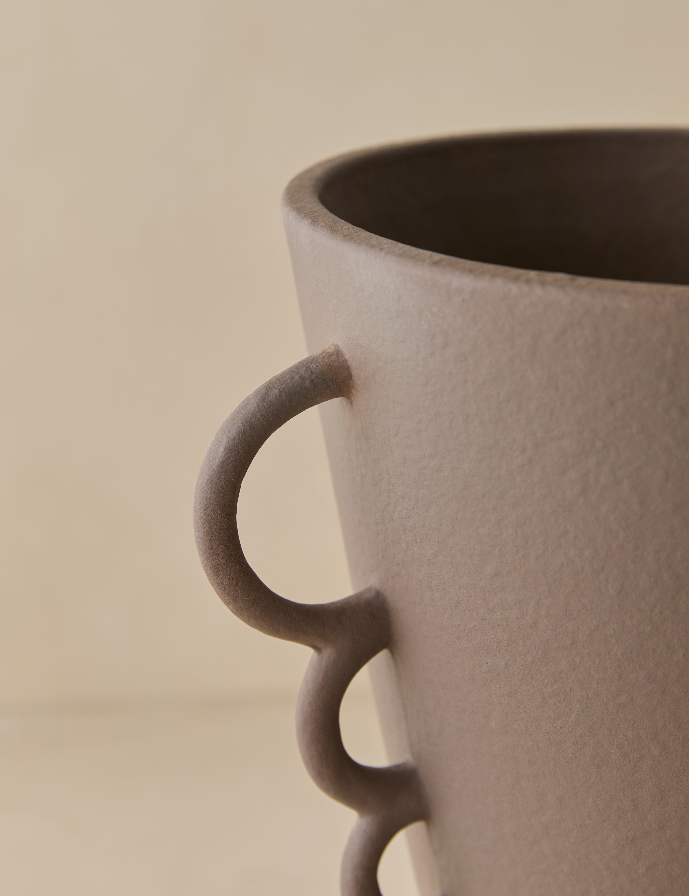 Close up view of the Panthea textural tapered loop handle ceramic vase by Aimee Song