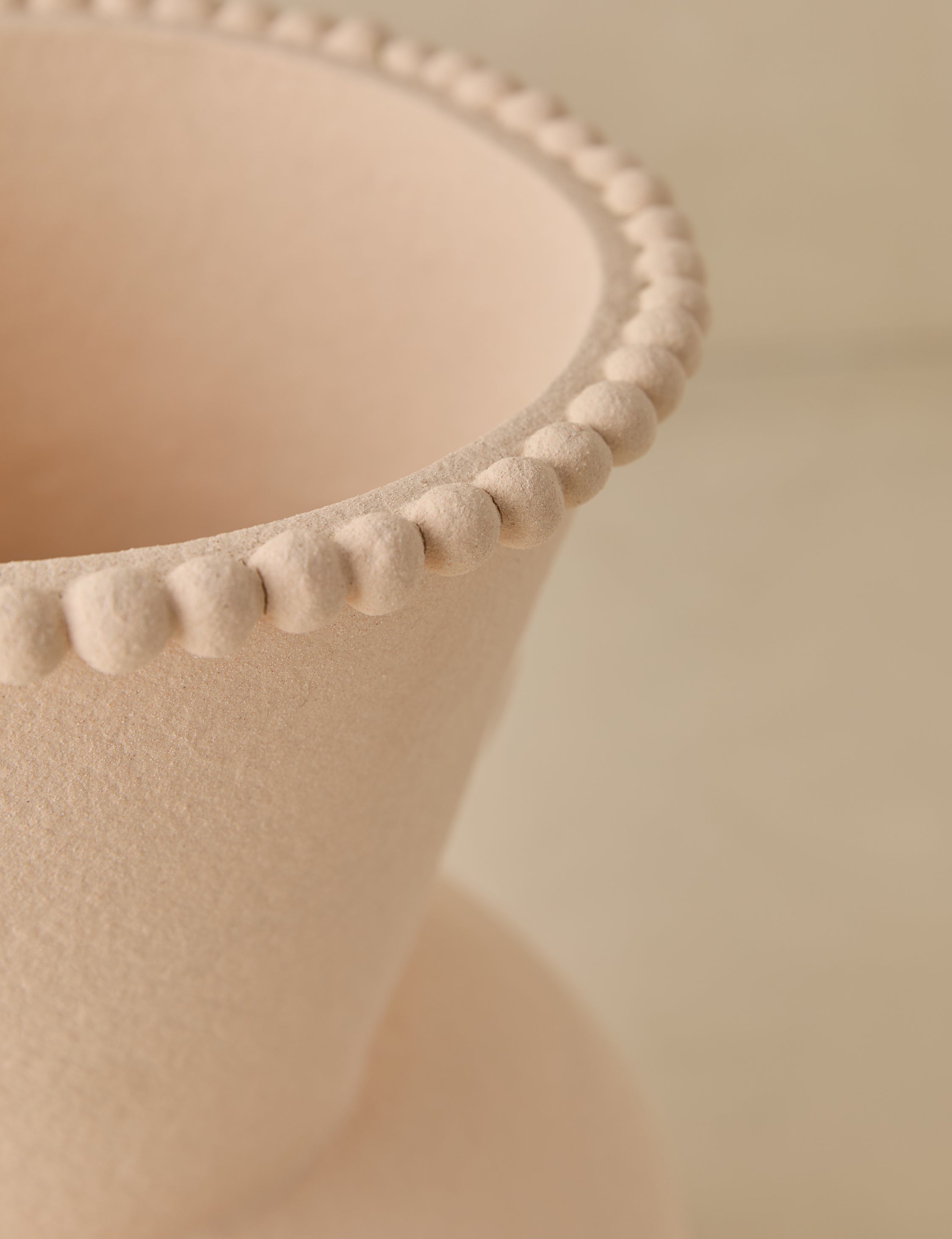 Close up view of the Philia wide beaded rim loop handle ceramic vase by Aimee Song