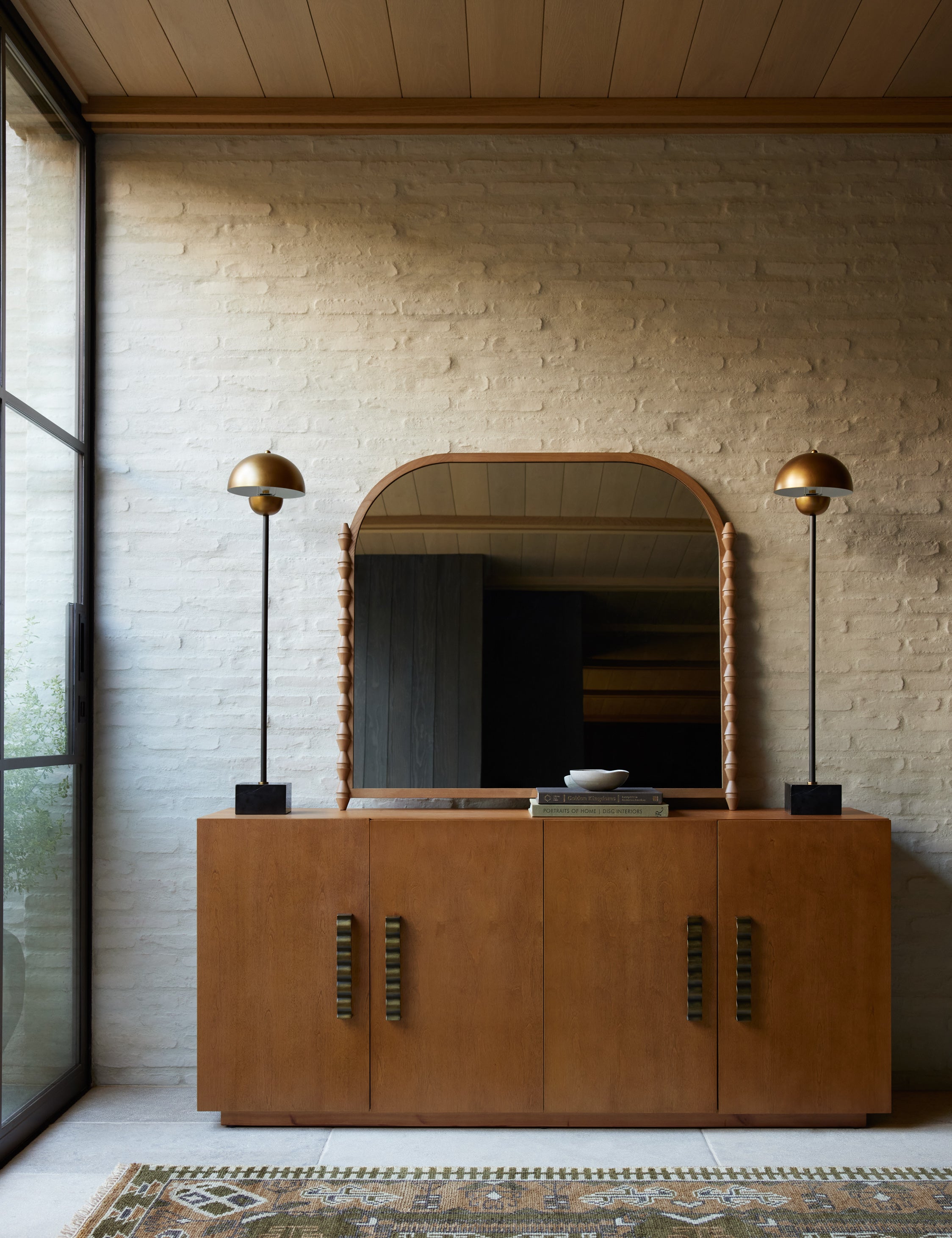 Fielder mid-century modern 4-door sideboard cabinet styled with a large mirror and two bronze dome tall table lamps.