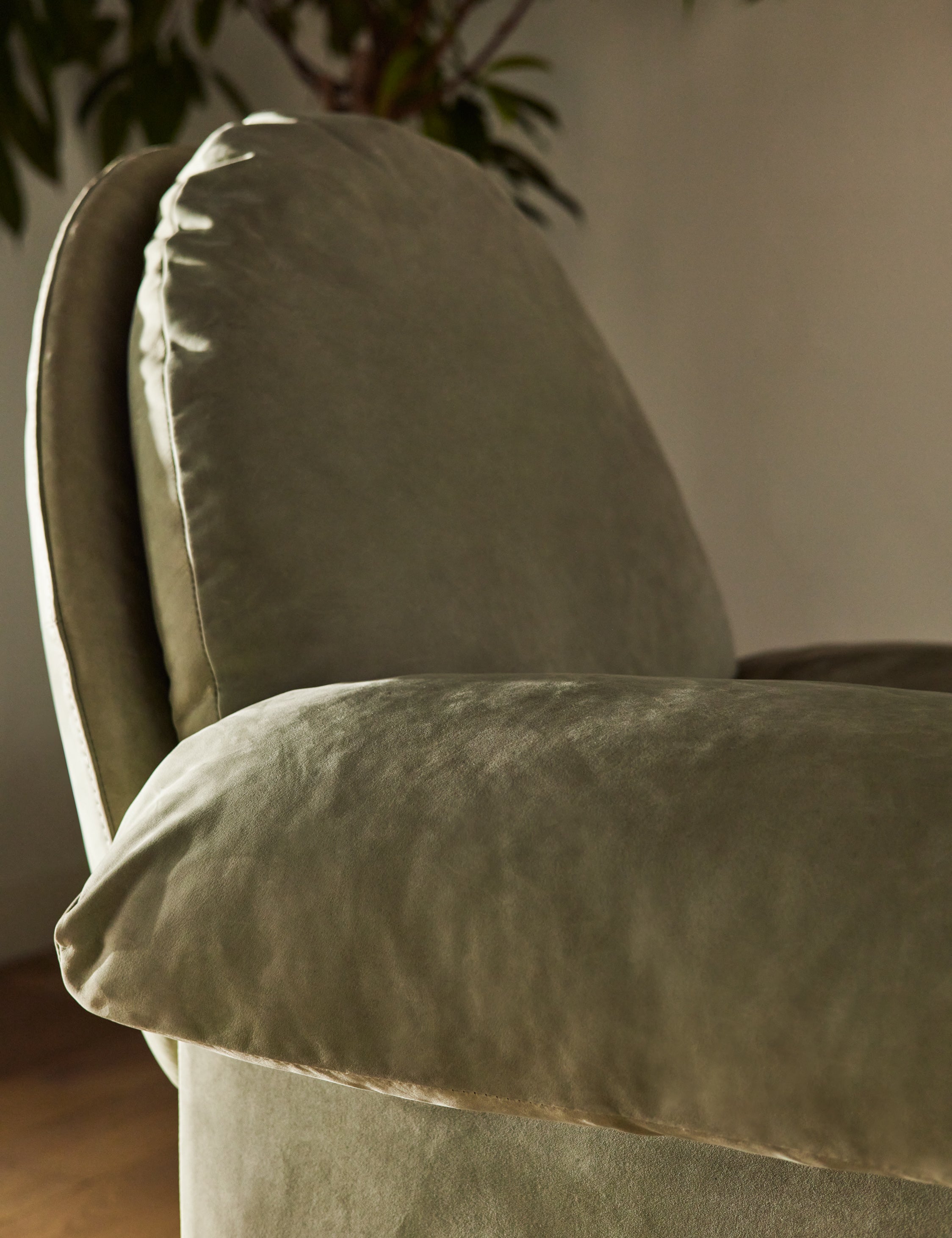  Close up of the arm of the Nolina relaxed open profile leather accent chair by Carly Cushnie.