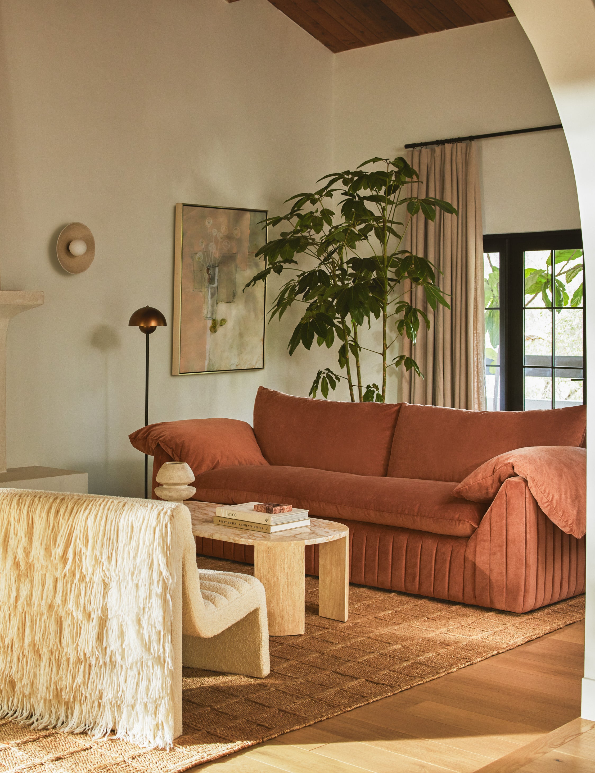  Living room featuring the Yucca relaxed profile wide arm sofa by Carly Cushnie.