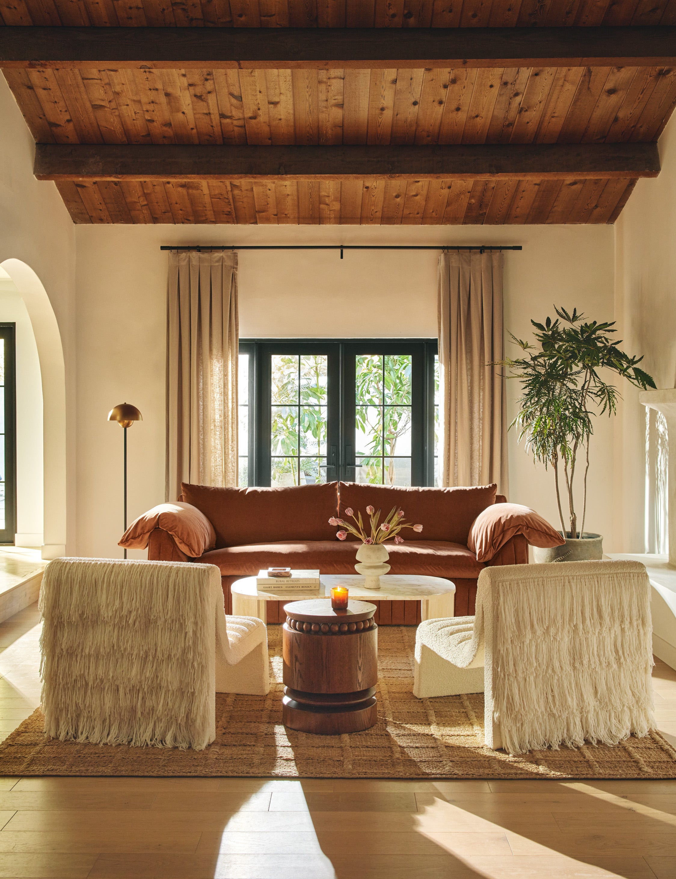 Living room featuring the Coco round drum beaded wood side table by Carly Cushnie.