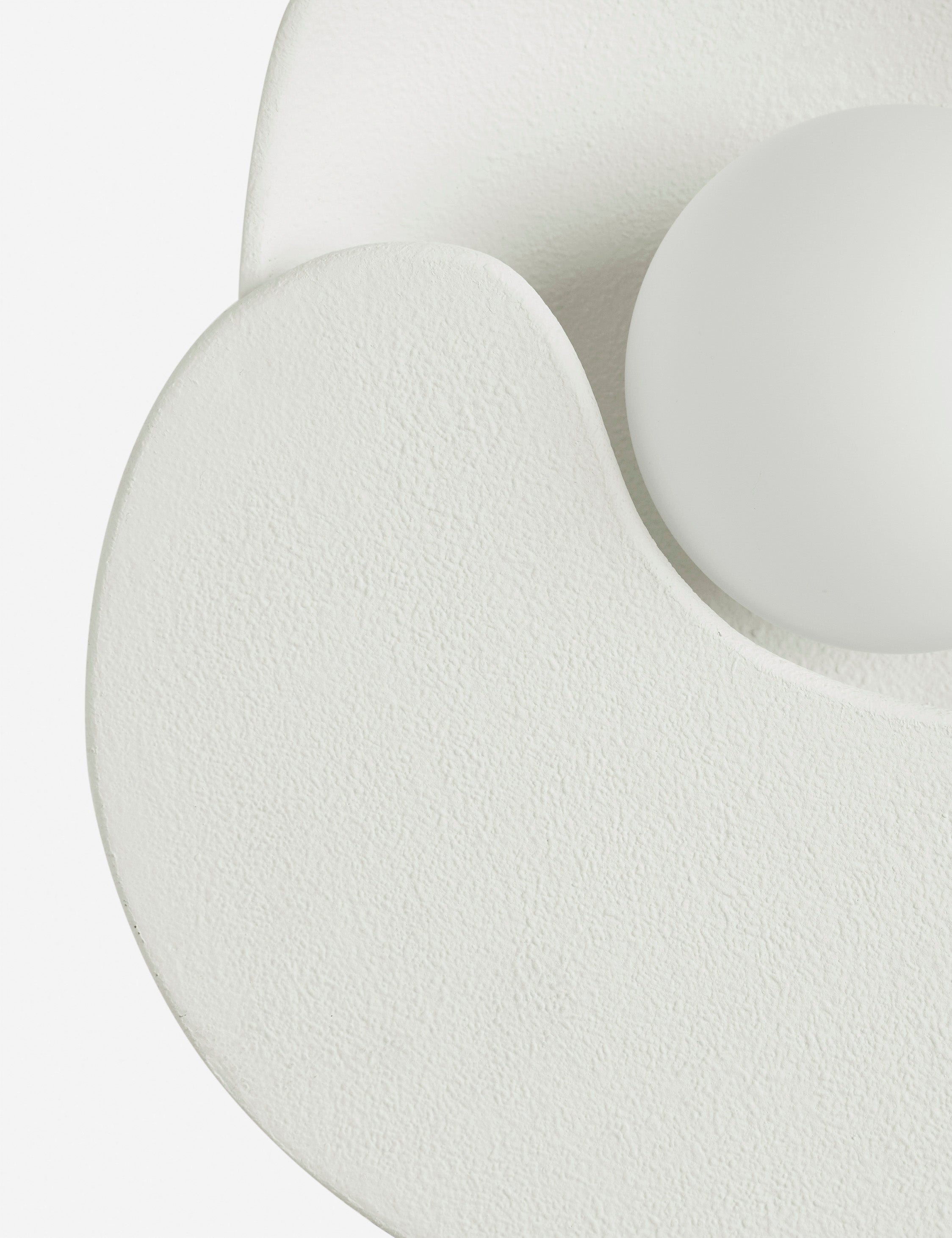 Close up view of the Soft Petal matte white floral silhouette wall sconce light