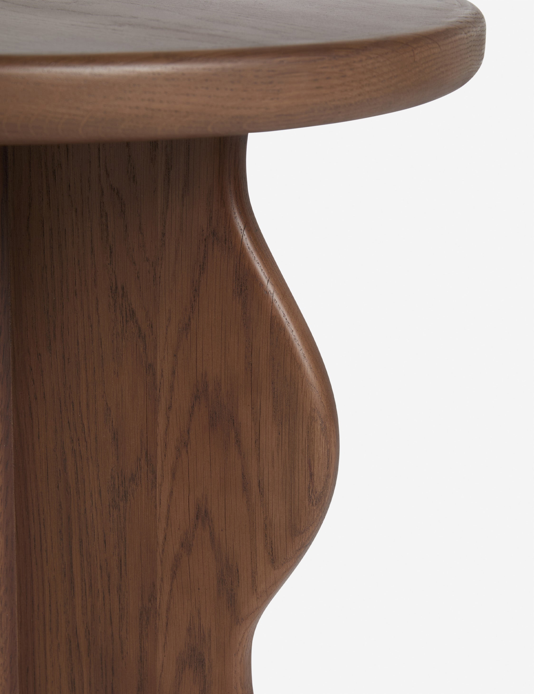 Close up view of the Telle wavy leg solid wood round side table by Aimee Song