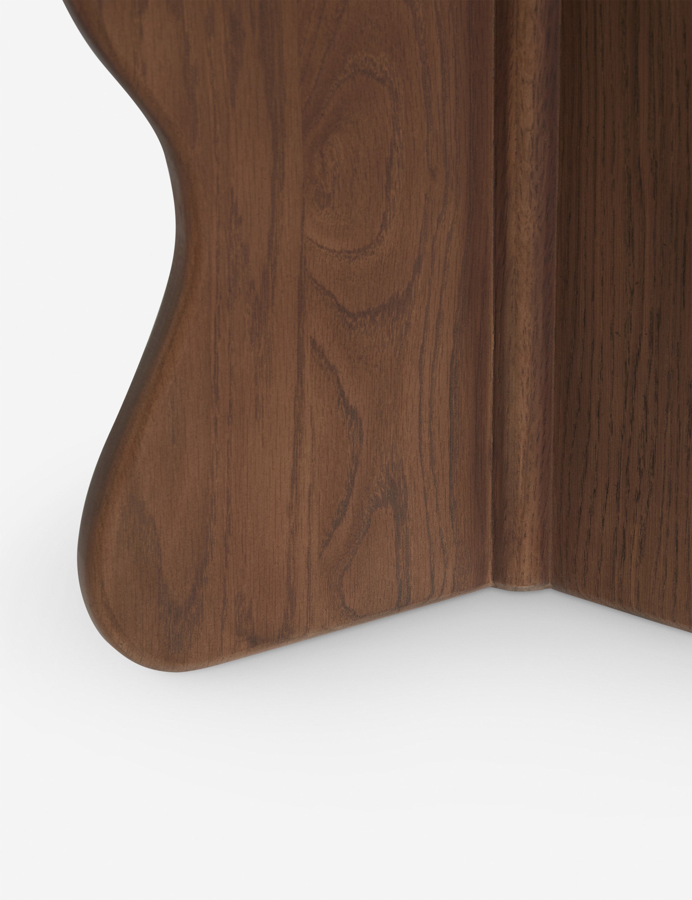 Close up view of the base of the Telle wavy leg solid wood round side table by Aimee Song