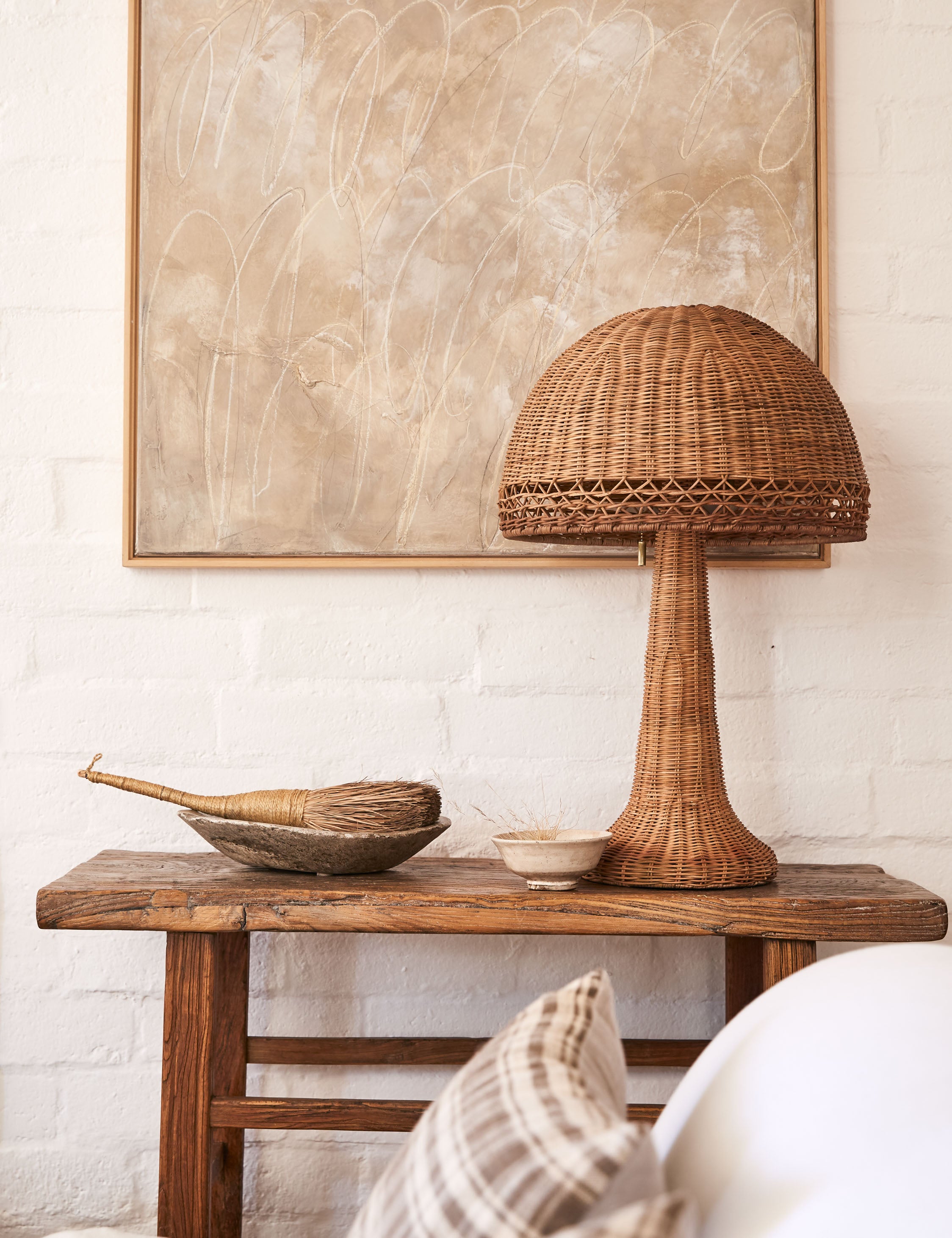 Quinley dome rattan coast table lamp styled on a rustic accent table.