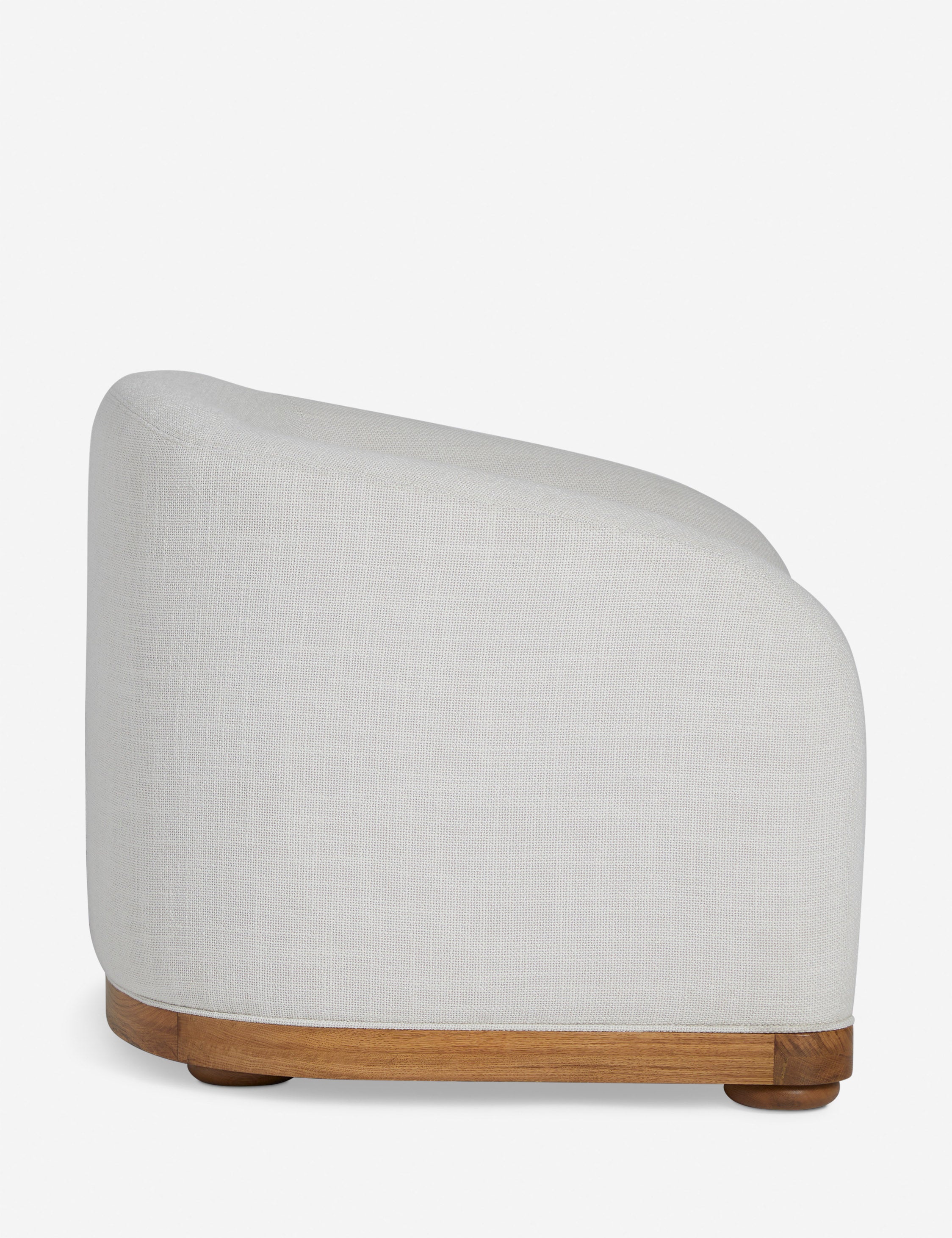 Side view of the Marci off white low barrel design accent chair