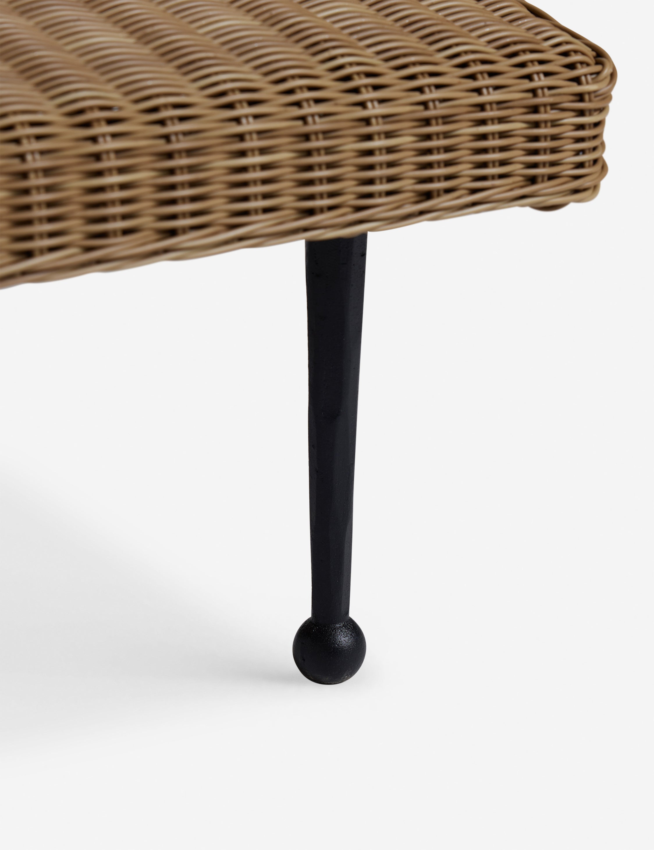 Close up of the leg of the Marisol sculptural wicker outdoor chaise by Sarah Sherman Samuel.
