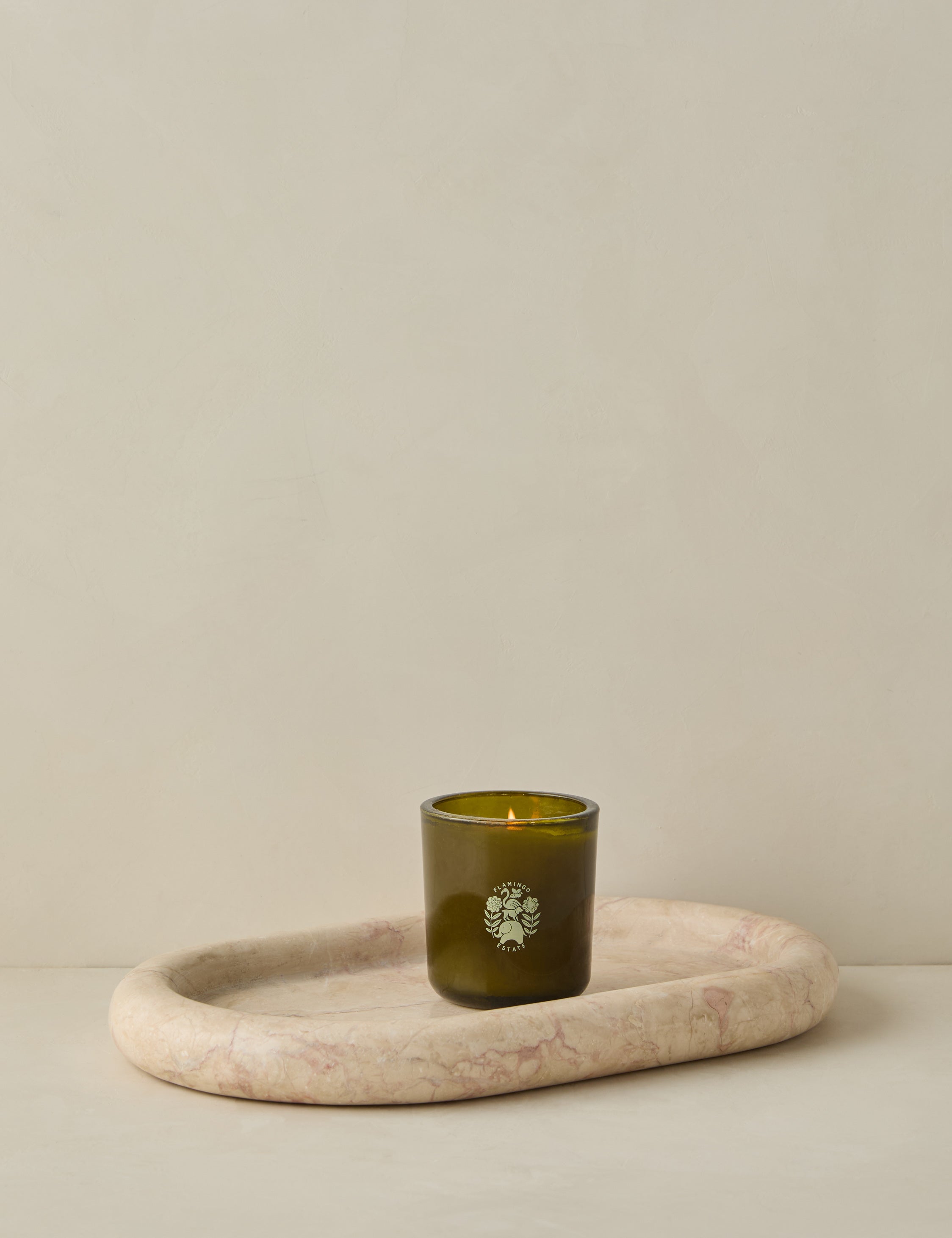 Besser marble oval tray holding a small candle.