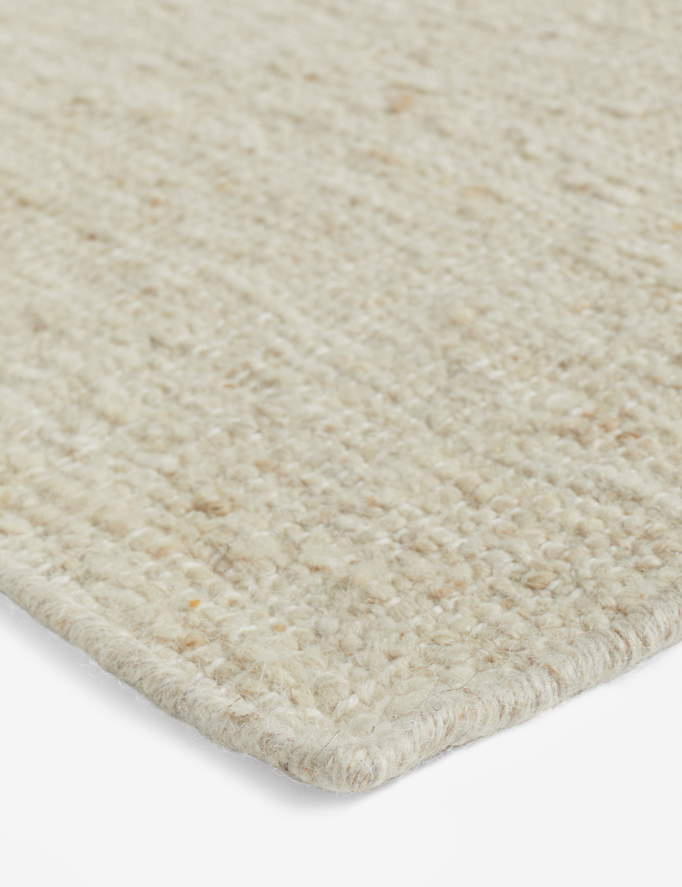 Close up view of the corner of the Mosaic Handwoven Wool Rug by Elan Byrd.