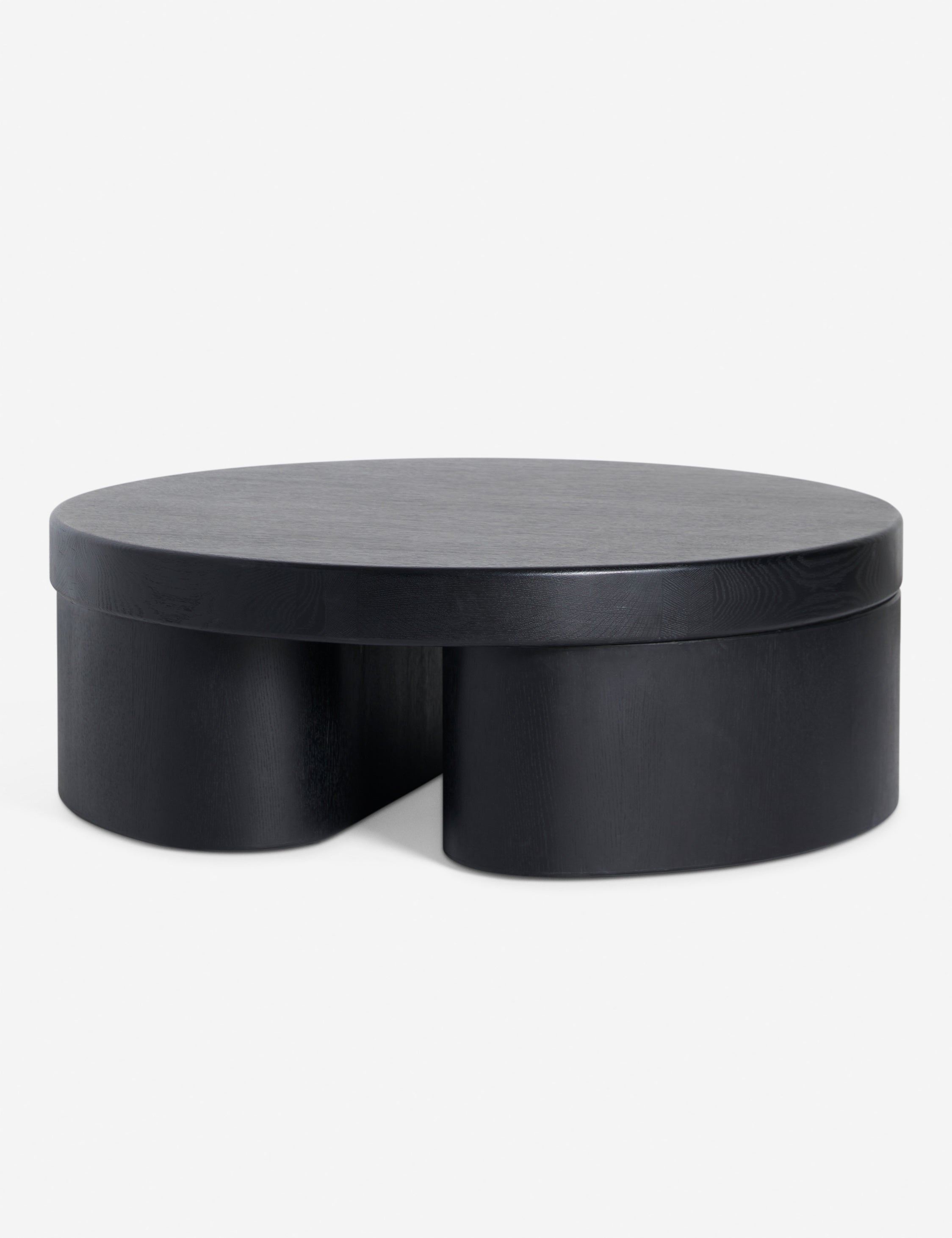 Angled view of Olga round modern black oak coffee table