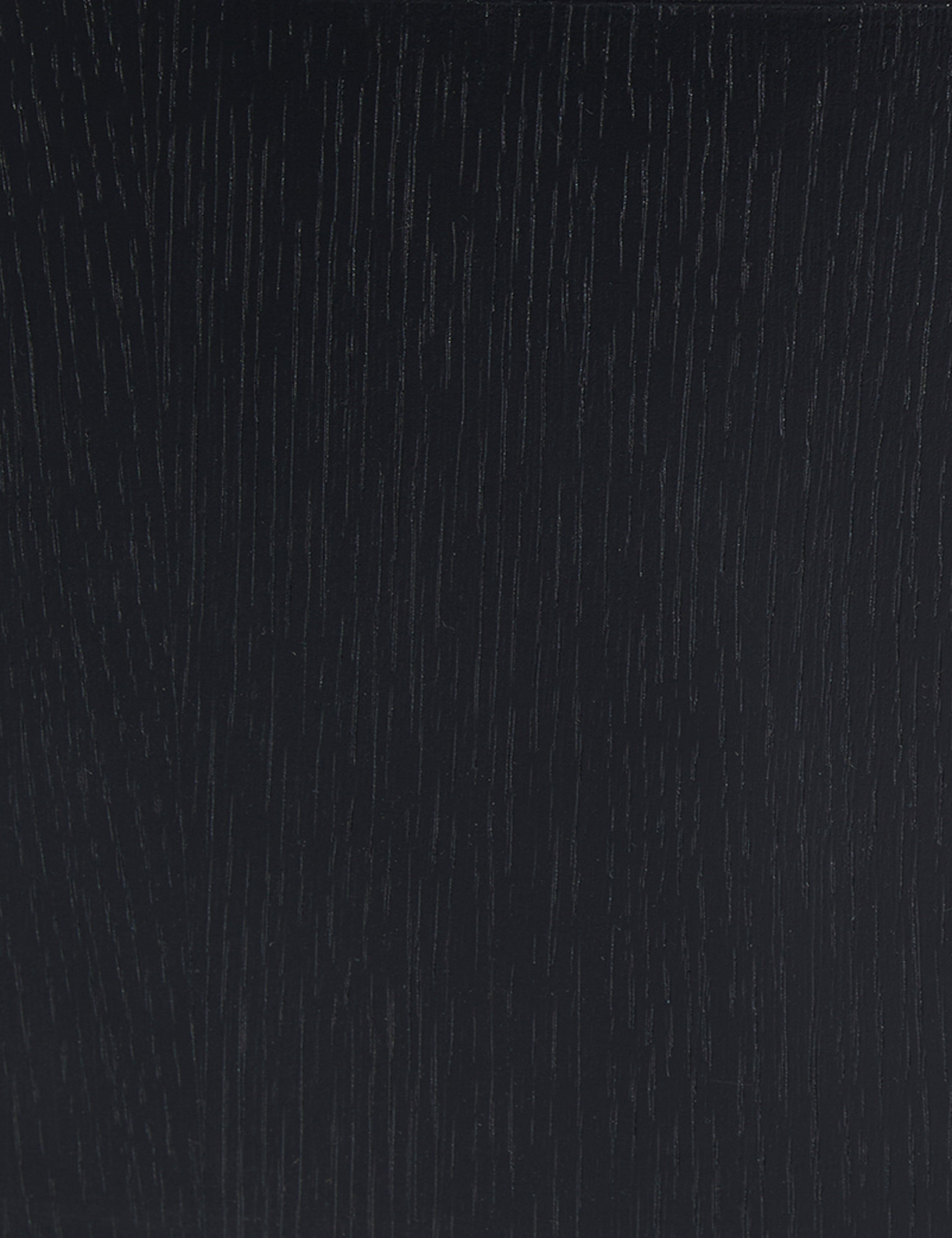 Close up view of the black oak wood grain of the Olga round coffee table
