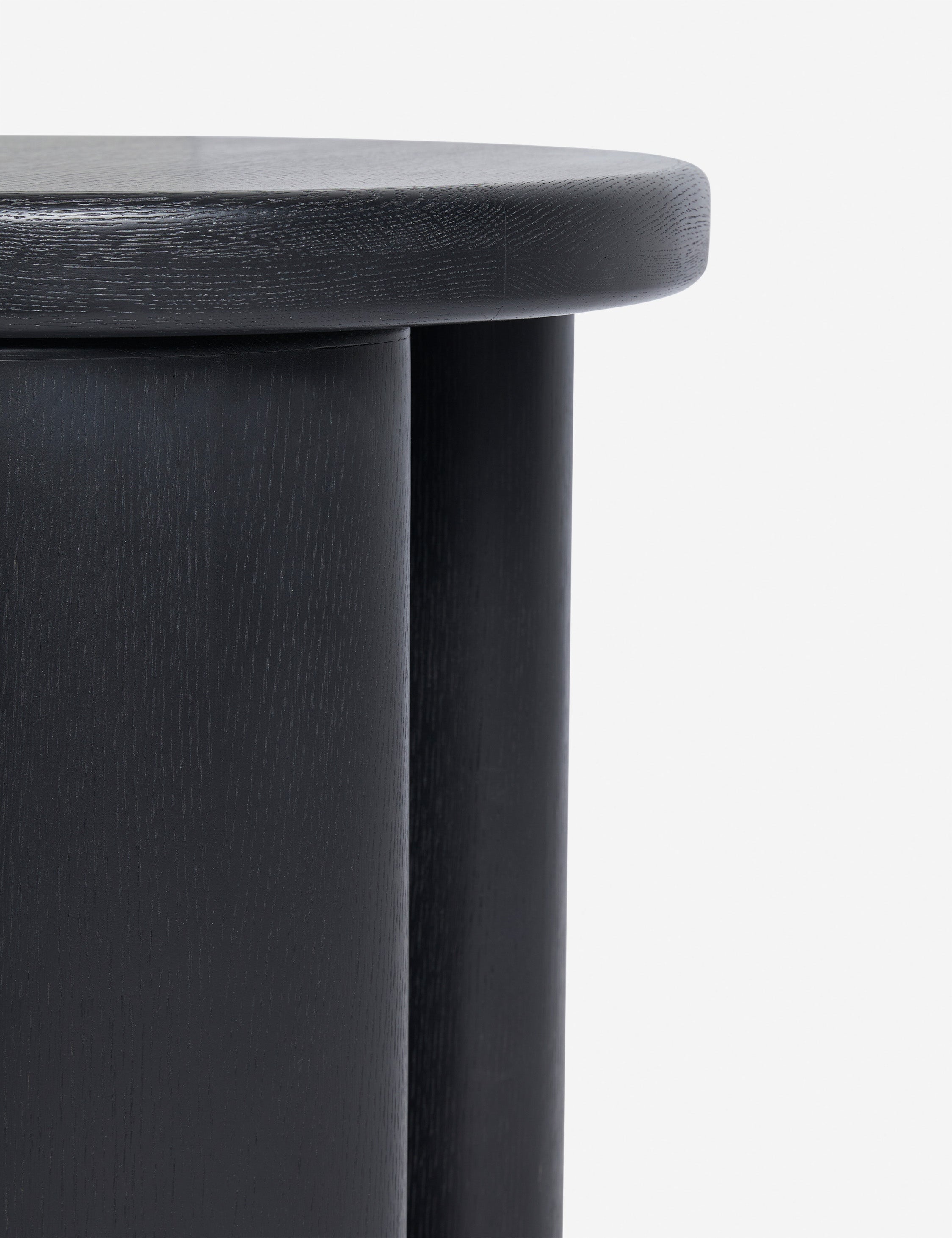 Close up view of the Olga round modern black oak side table