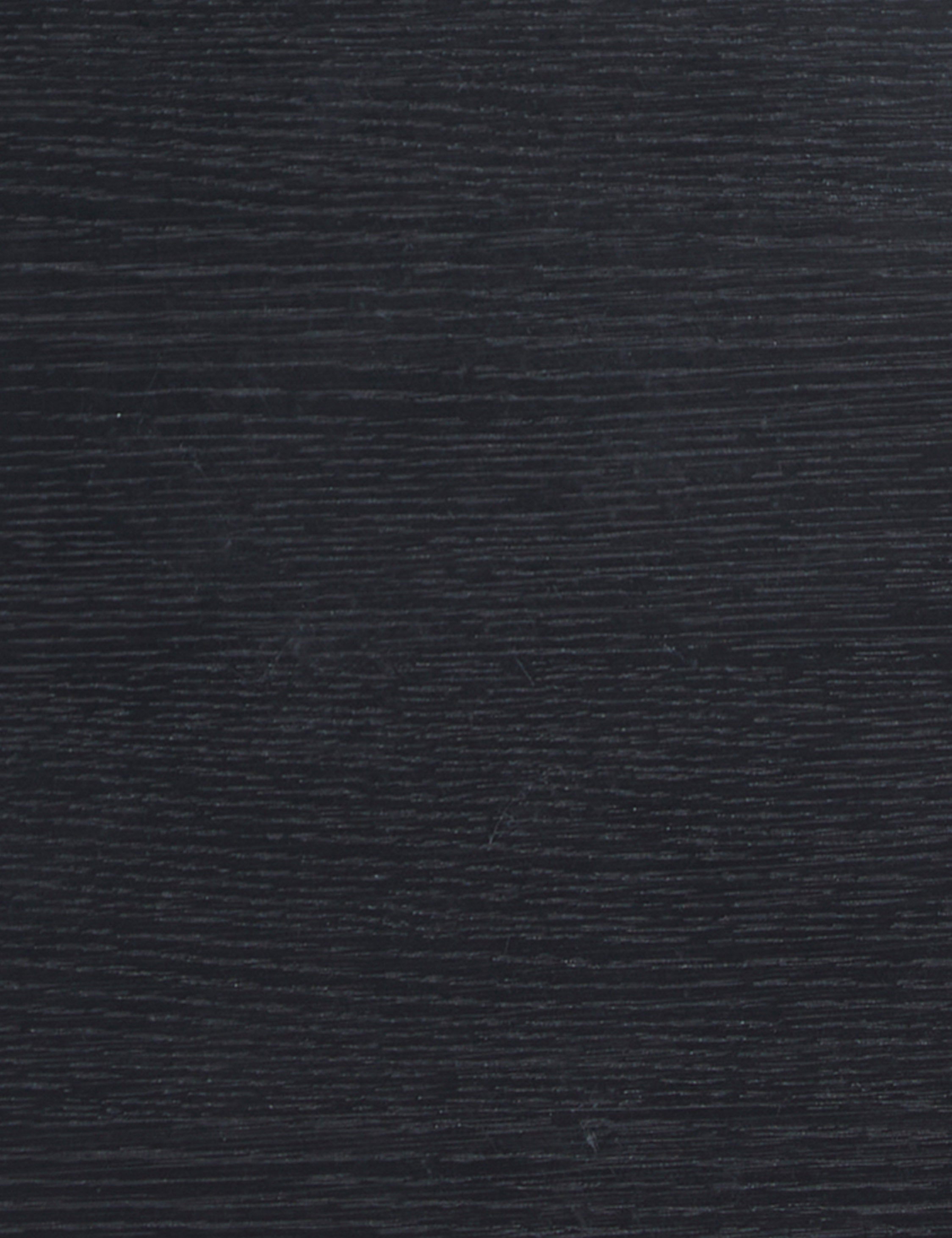 Close up view of the black oak wood grain of the Olga round side table