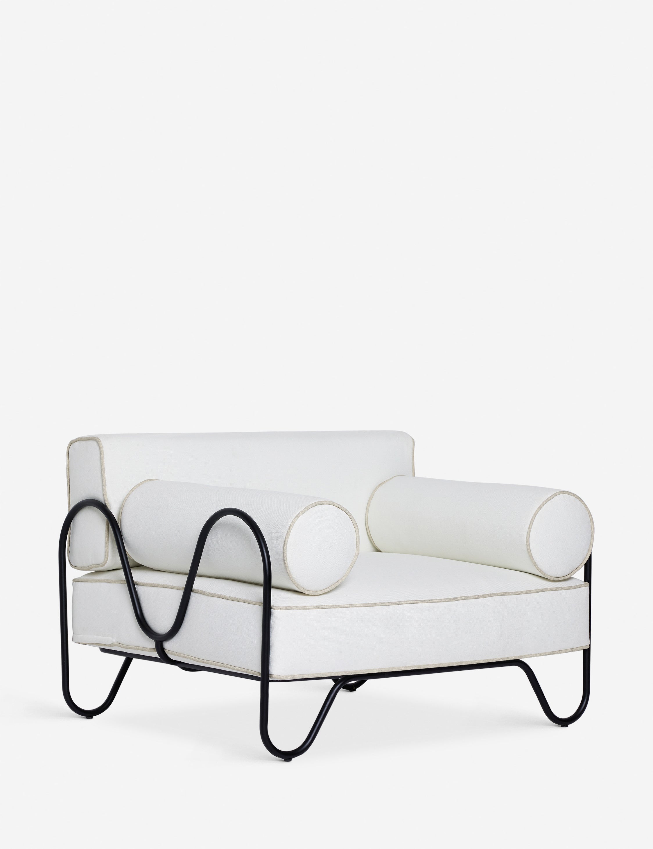 Angled view of the Peggy sculptural iron frame and white cushion outdoor accent chair.