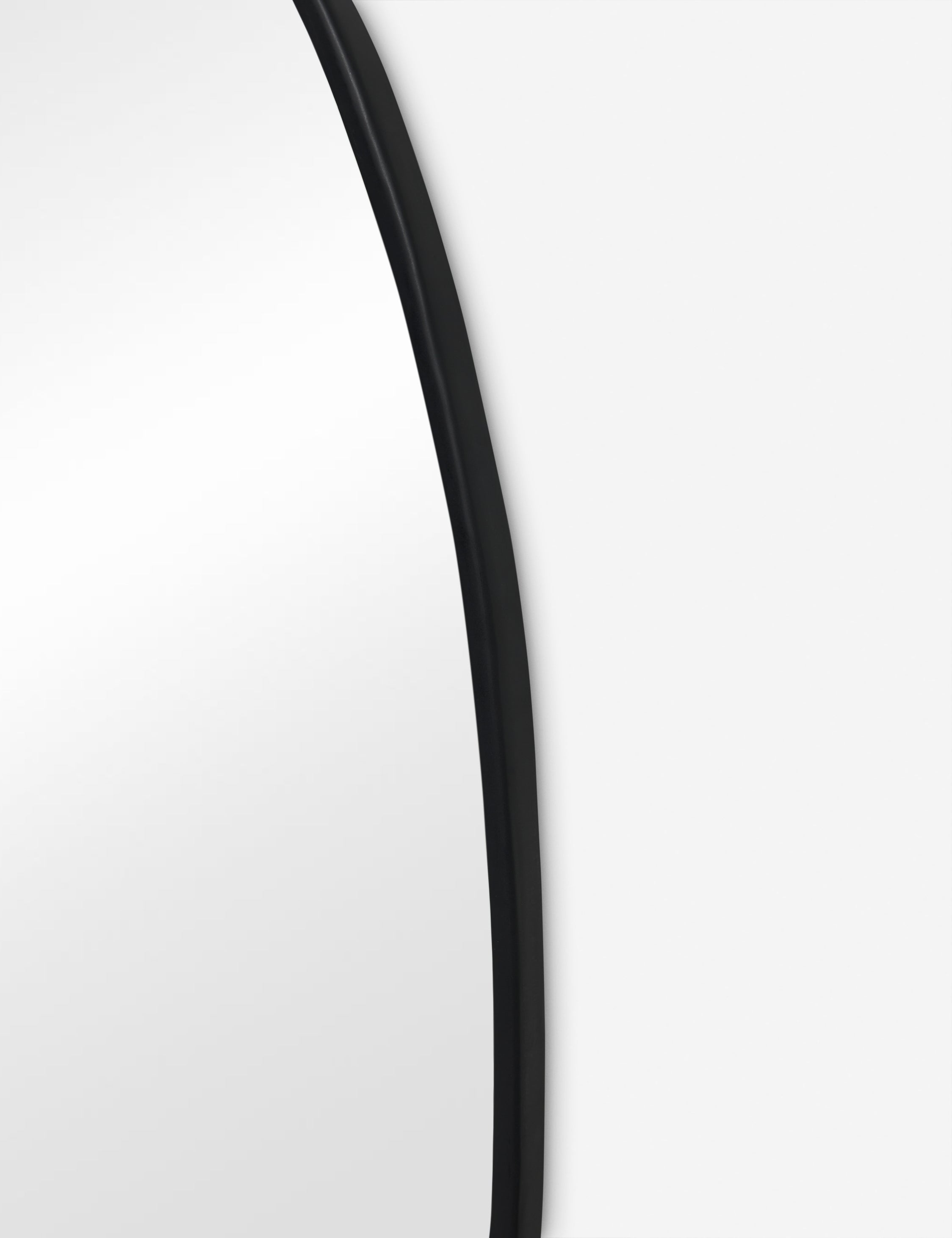 Close up view of the Puddle slim frame wall mirror in charcoal