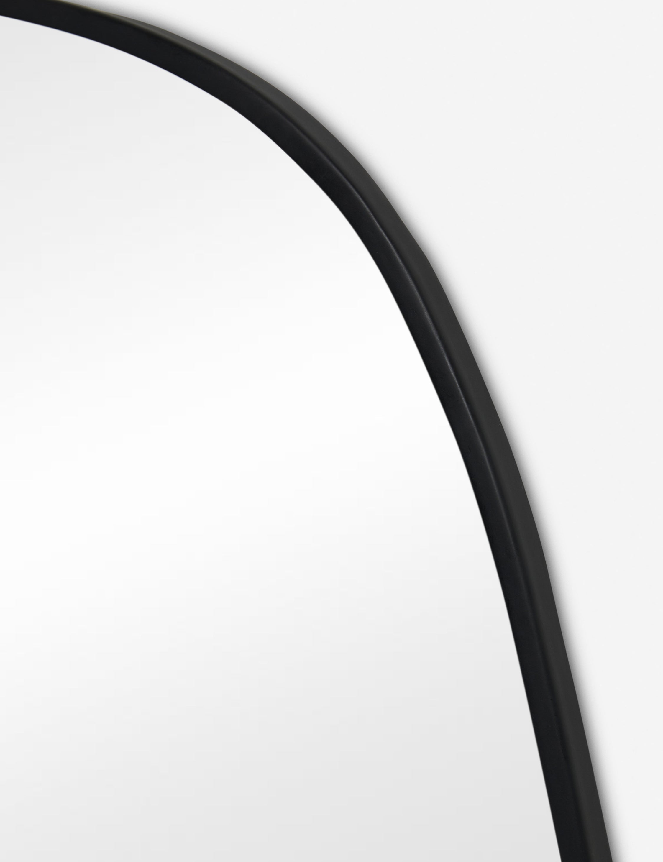 Close up view of the Puddle slim frame wall mirror in charcoal