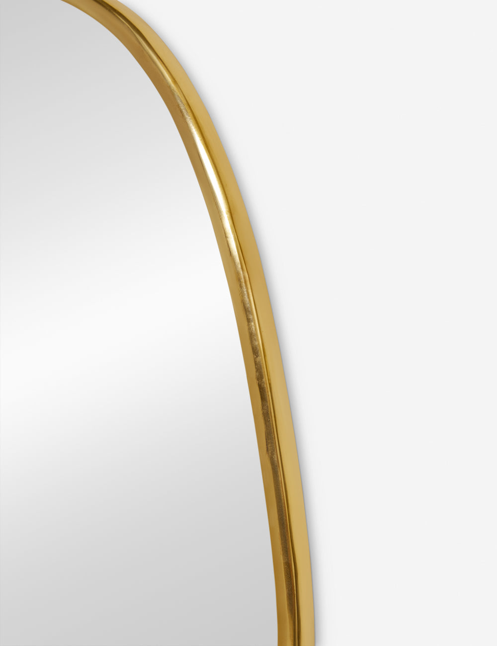 The gold curved frame on the small puddle mirror