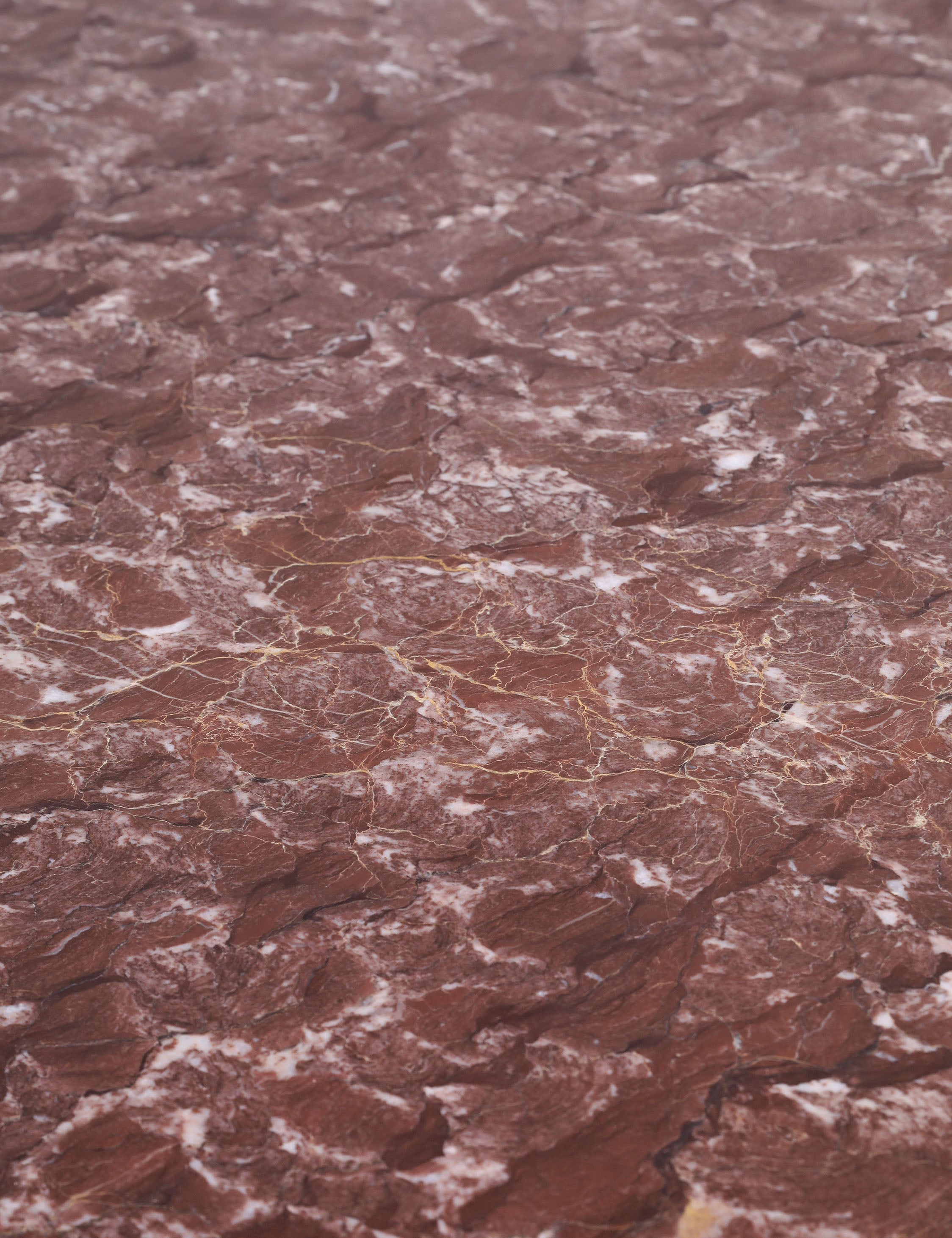 Close up of the top of the Ramoon wide leg solid marble dining table by Carly Cushnie.