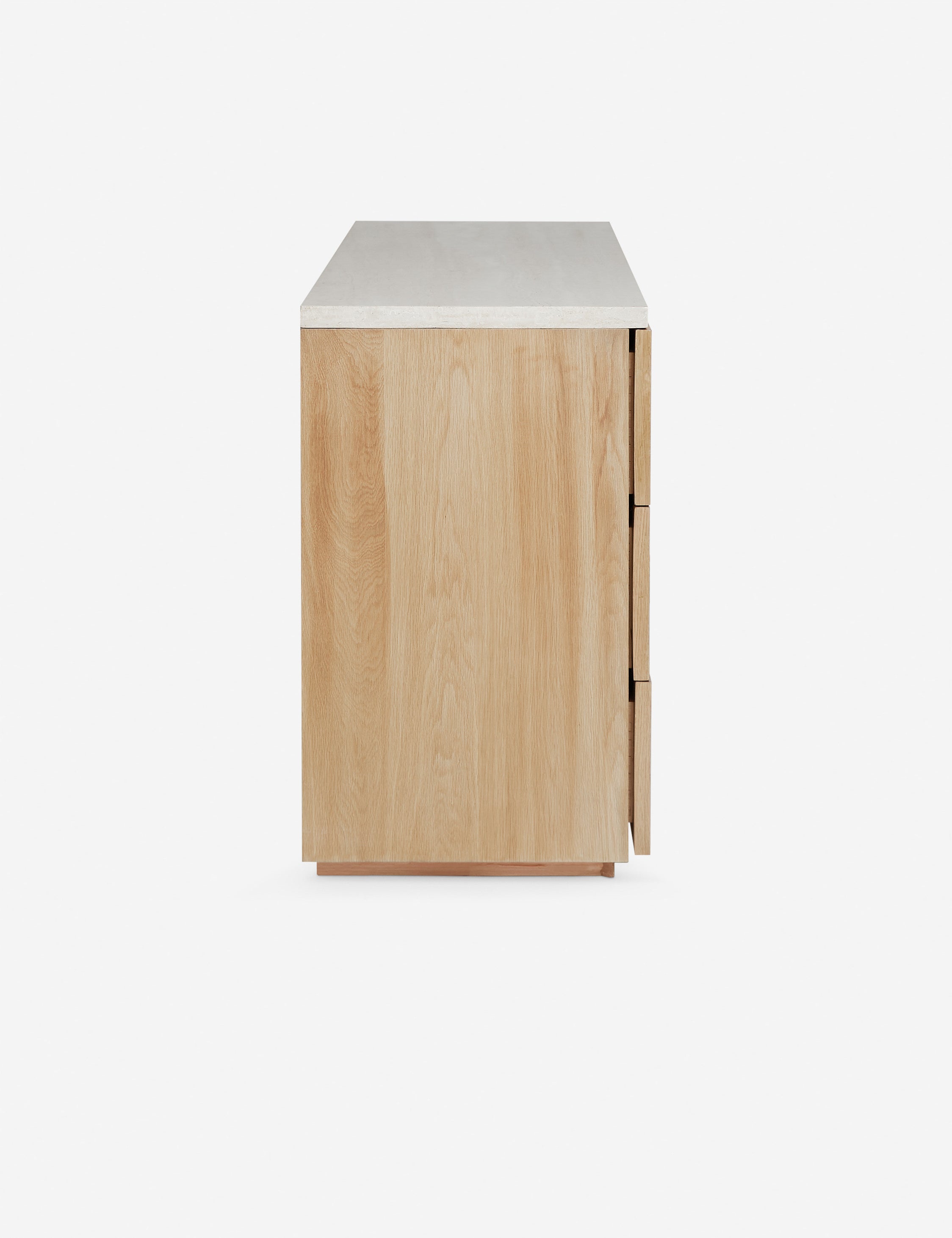 Side profile of the Rayner carved linear detailing oak six drawer dresser.