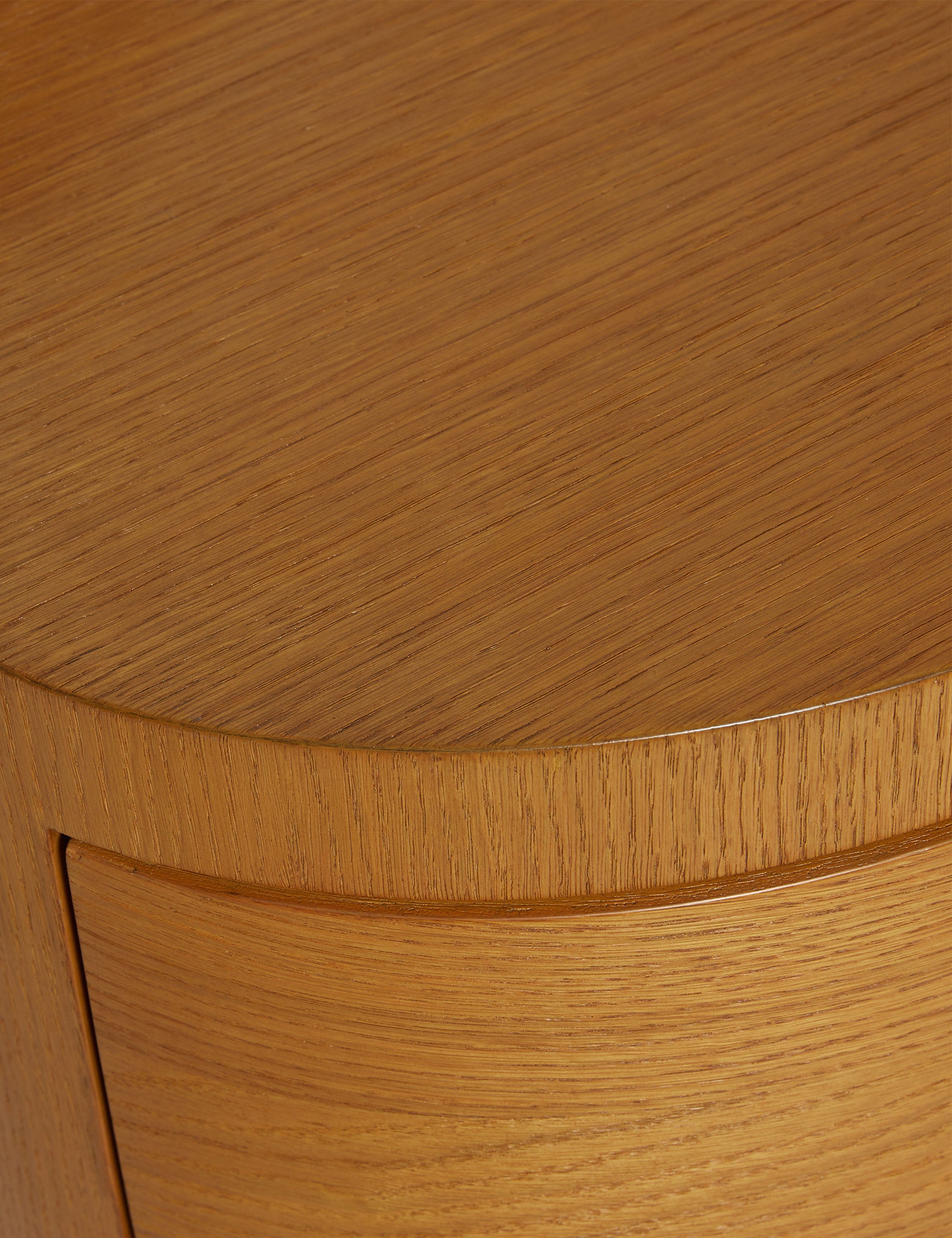Close up view of the Ripple wavy profile, round two drawer nightstand