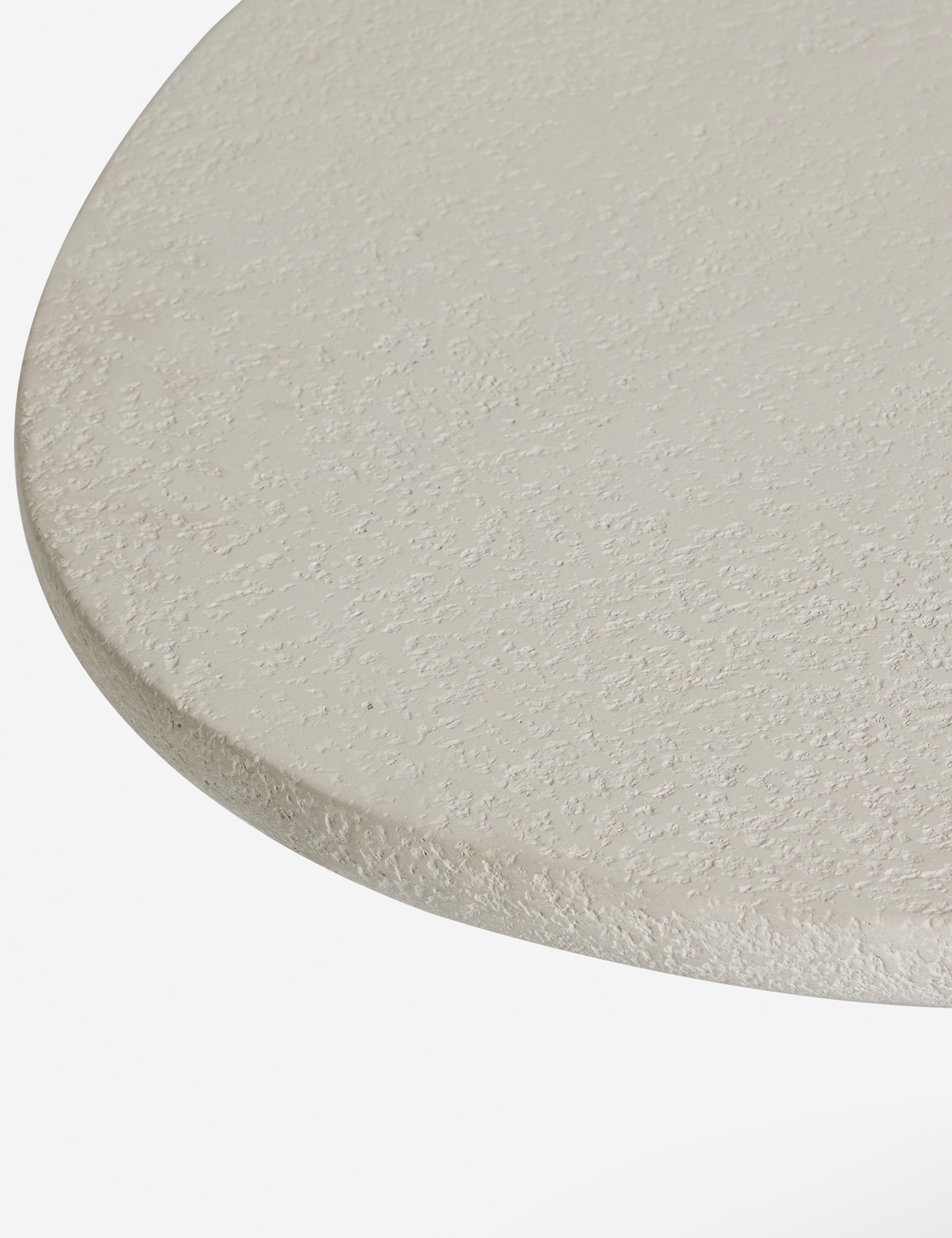 Close up of the Rodrigo sculptural oval outdoor dining table.
