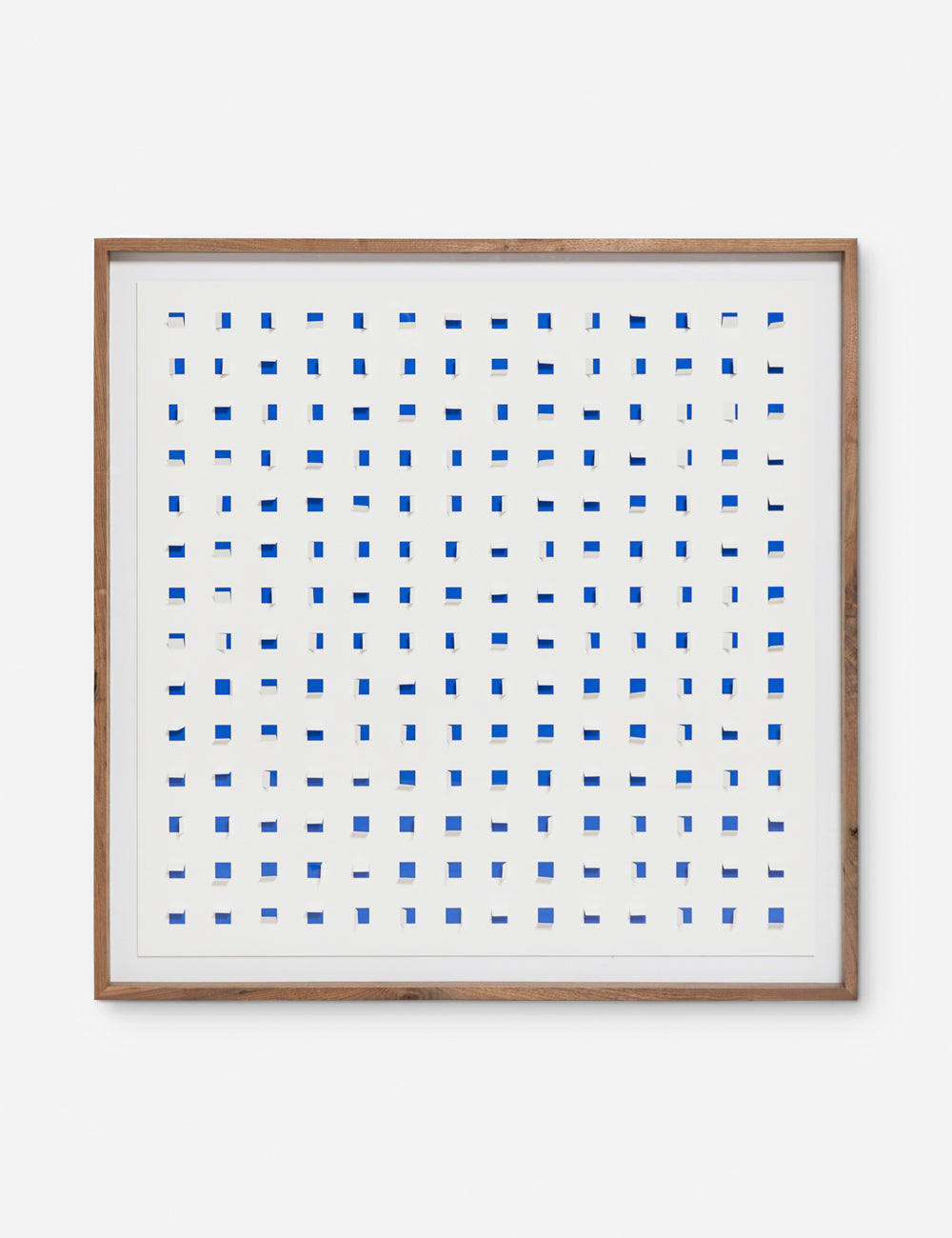 See Through cobalt blue and white wall art featuring square paper cutouts with flaps on a linen backdrop
