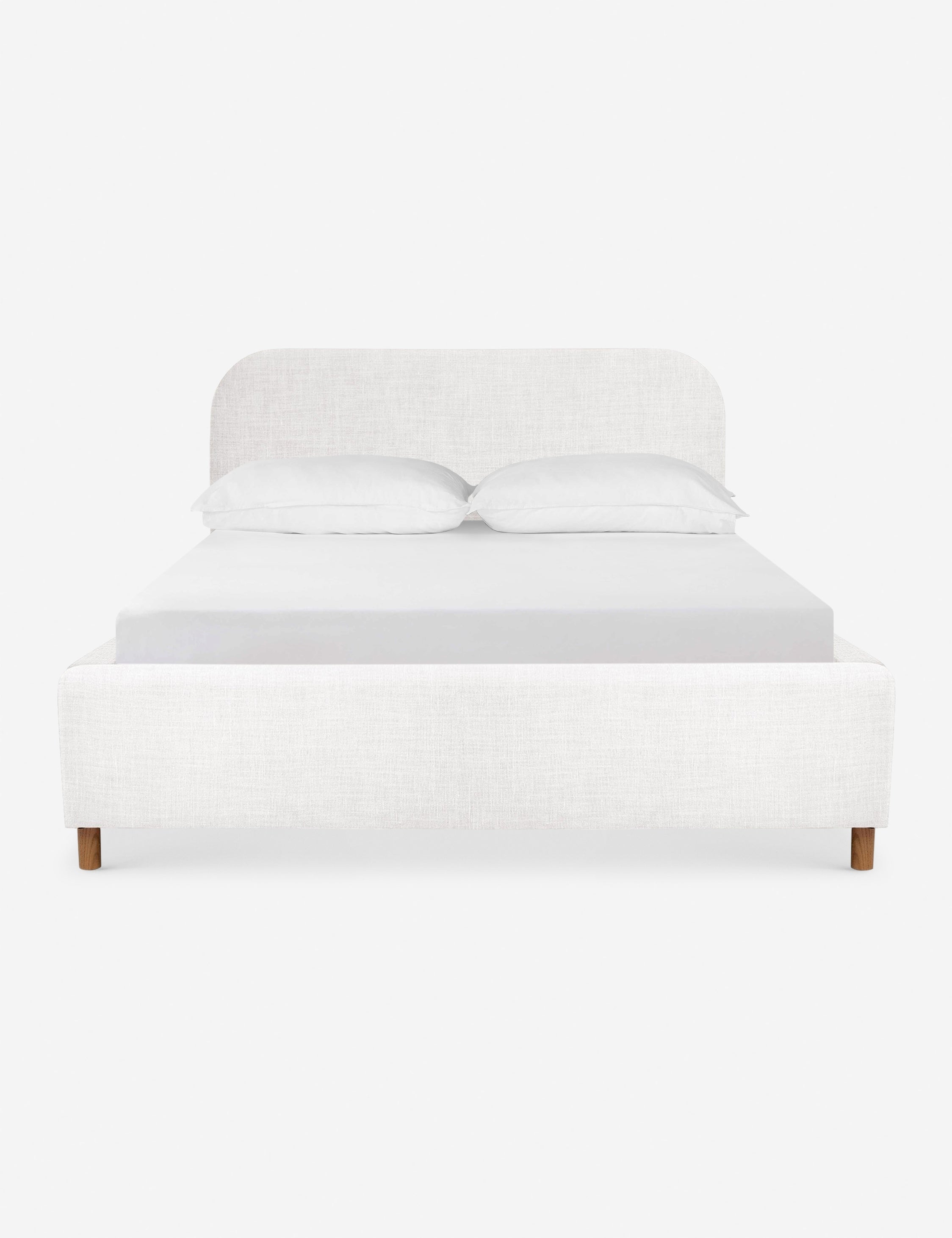 Solene White linen platform bed with an arched headboard and oak wood legs