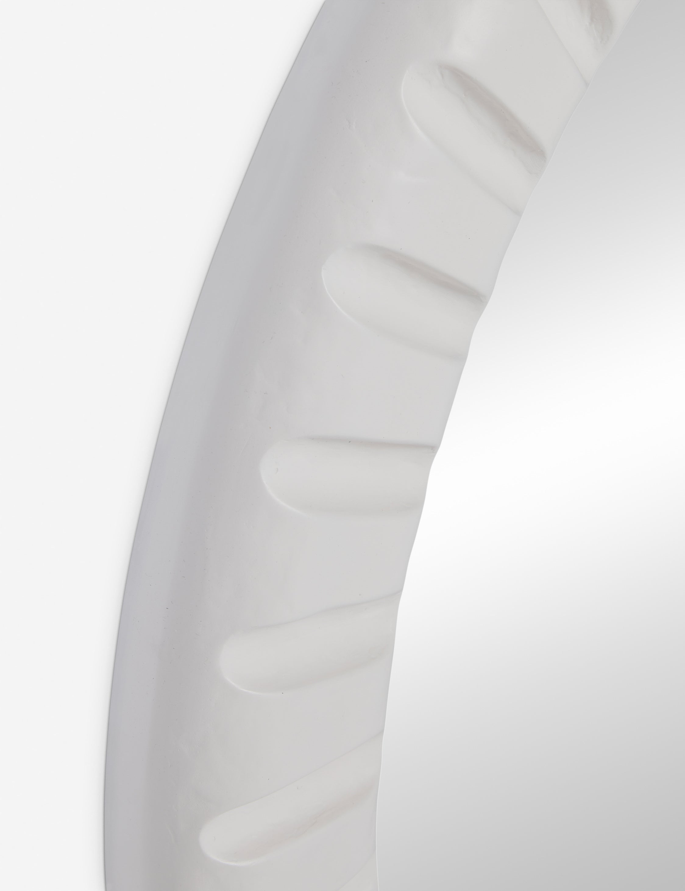 Angled close up of the Tapp white framed round wall mirror