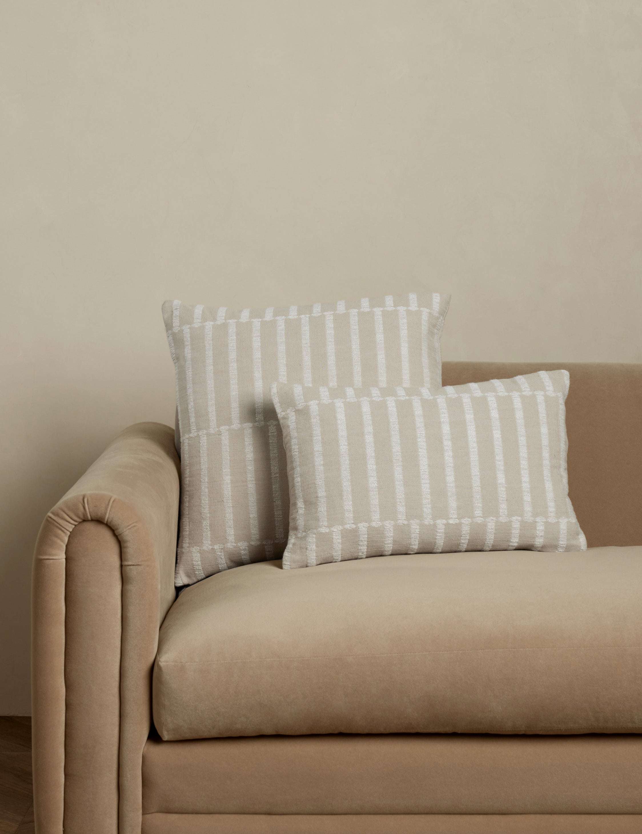 Thisbe offset stripe throw and lumbar pillows paired together on a sofa.
