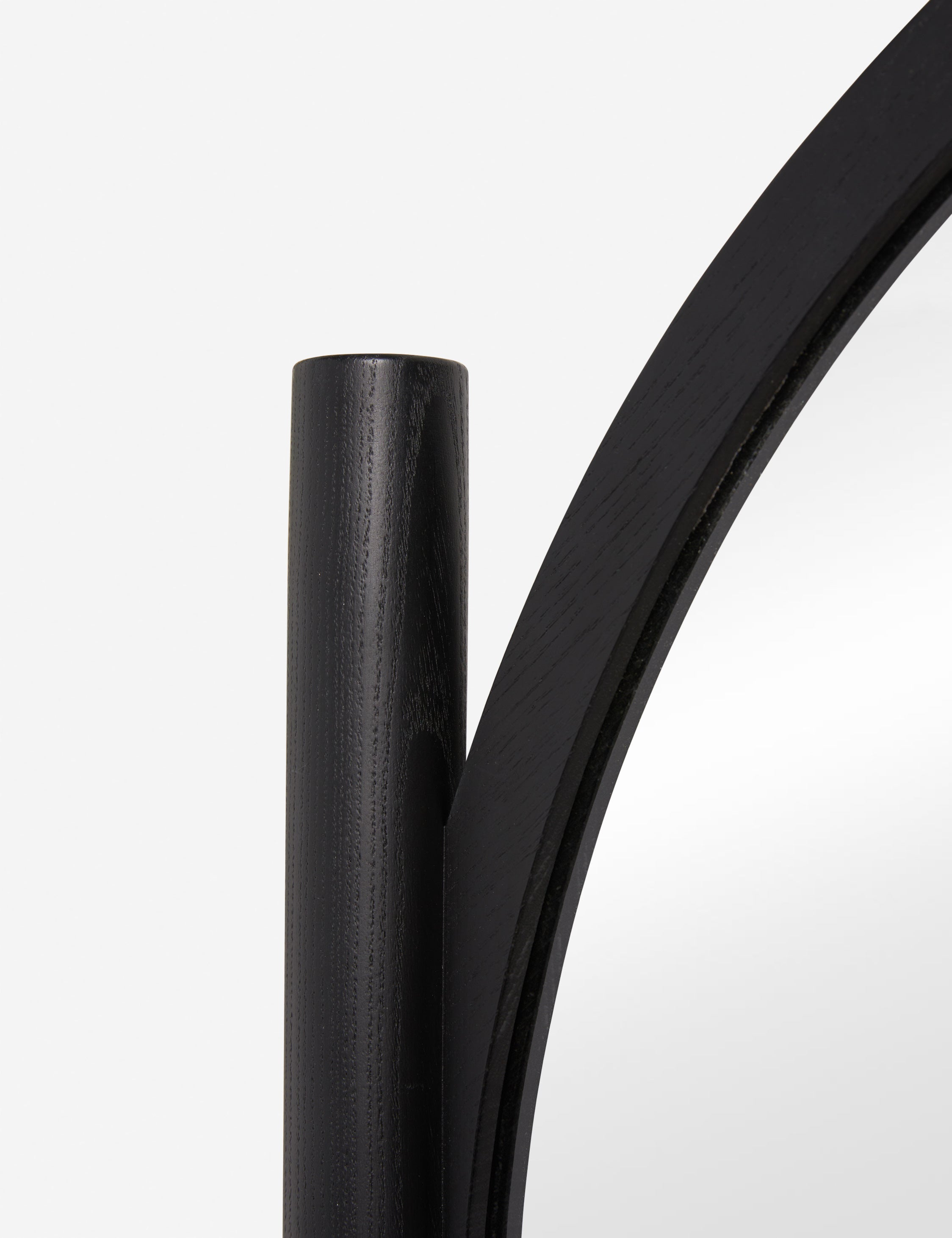 Close up of the frame of the Topia arched carved wood frame floor mirror by Ginny Macdonald in black.