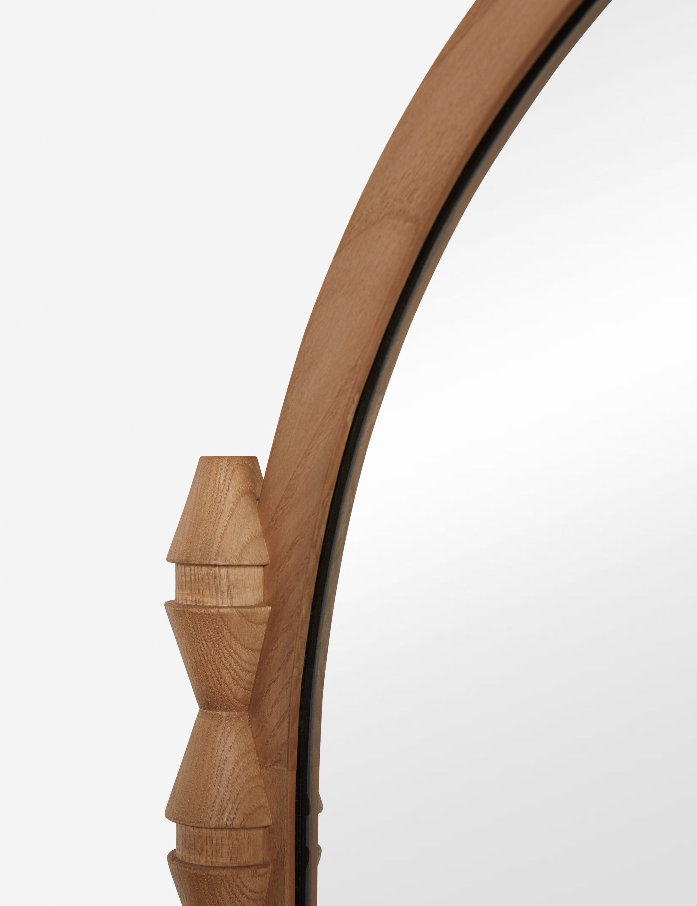 Close up of the Topia arched carved wood mantel mirror by Ginny Macdonald in natural.