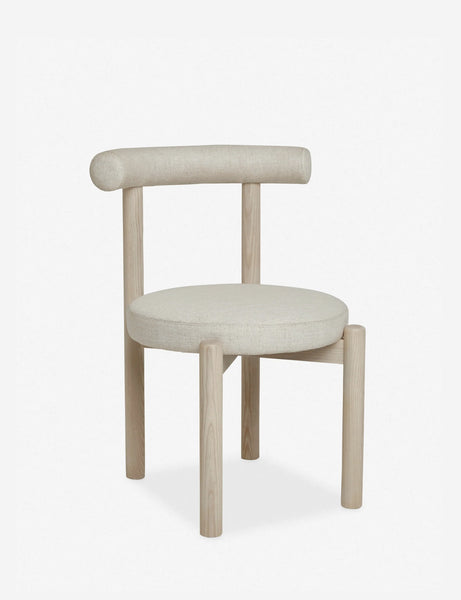 #color::whitewash | Angled left view of the Dame minimalist rounded open-back dining chair with ivory upholstered seat and ash wood frame