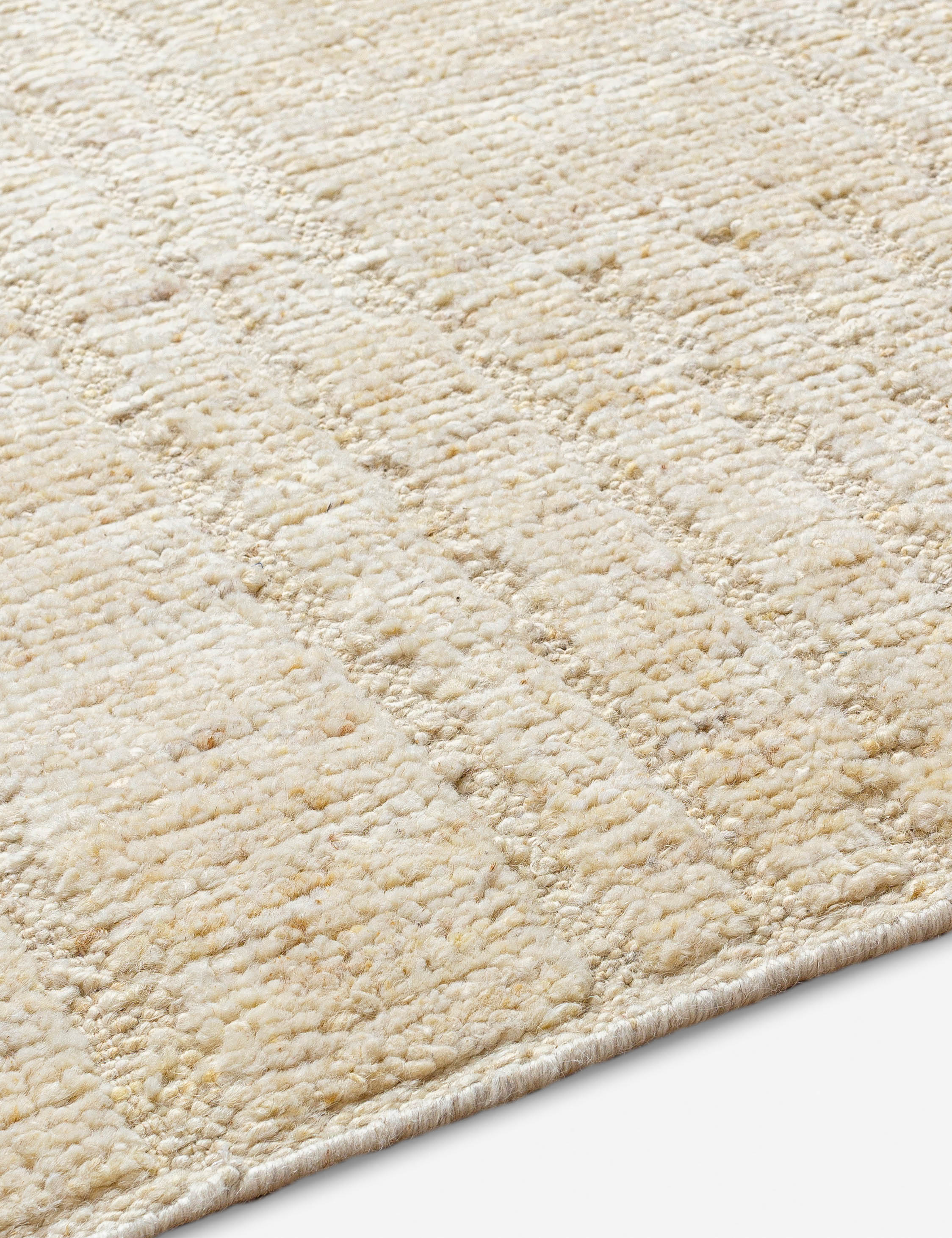 Close up angled view of the Malone textured ivory hand-knotted wool runner rug