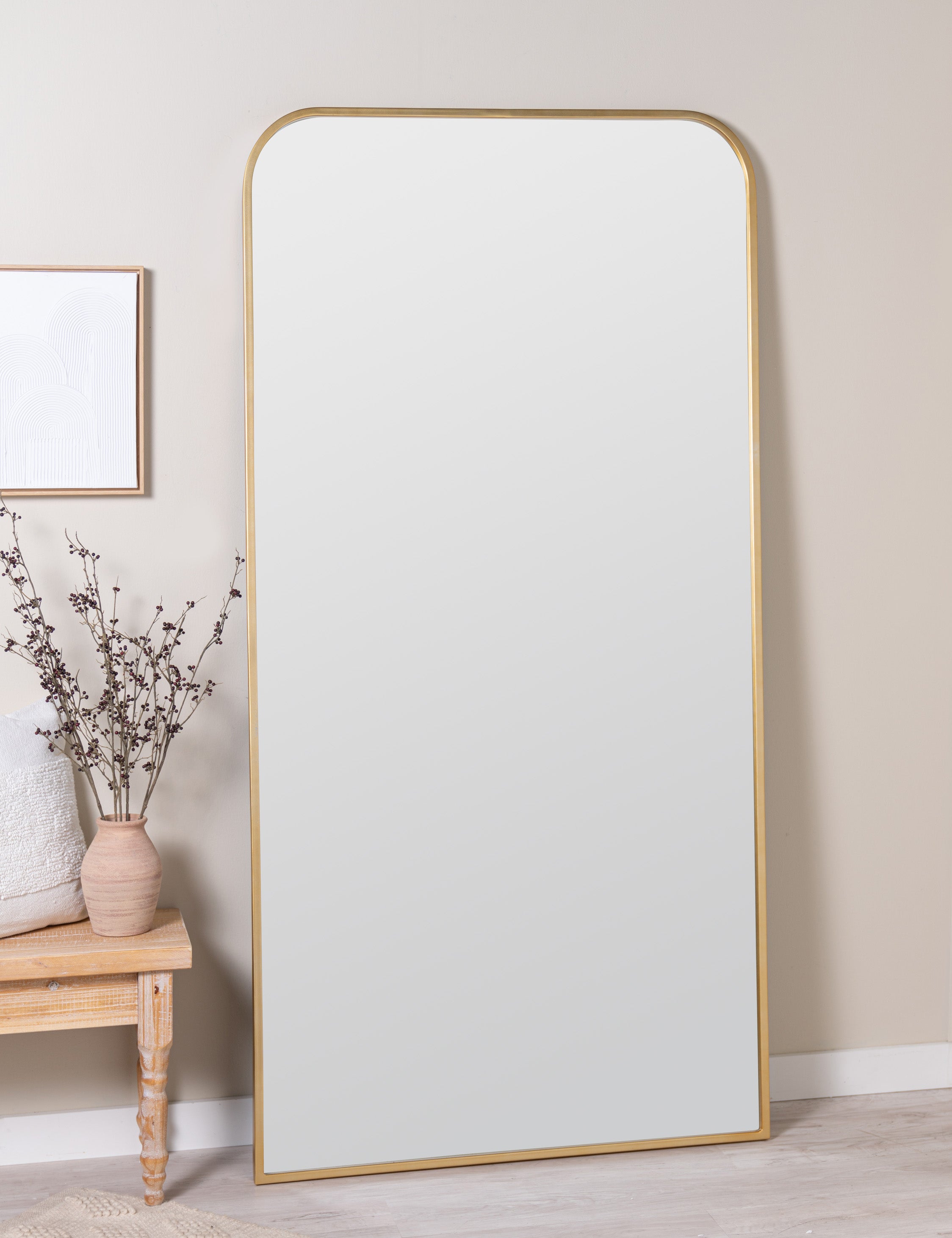Homare slim, slightly rounded full length mirror leaning against wall