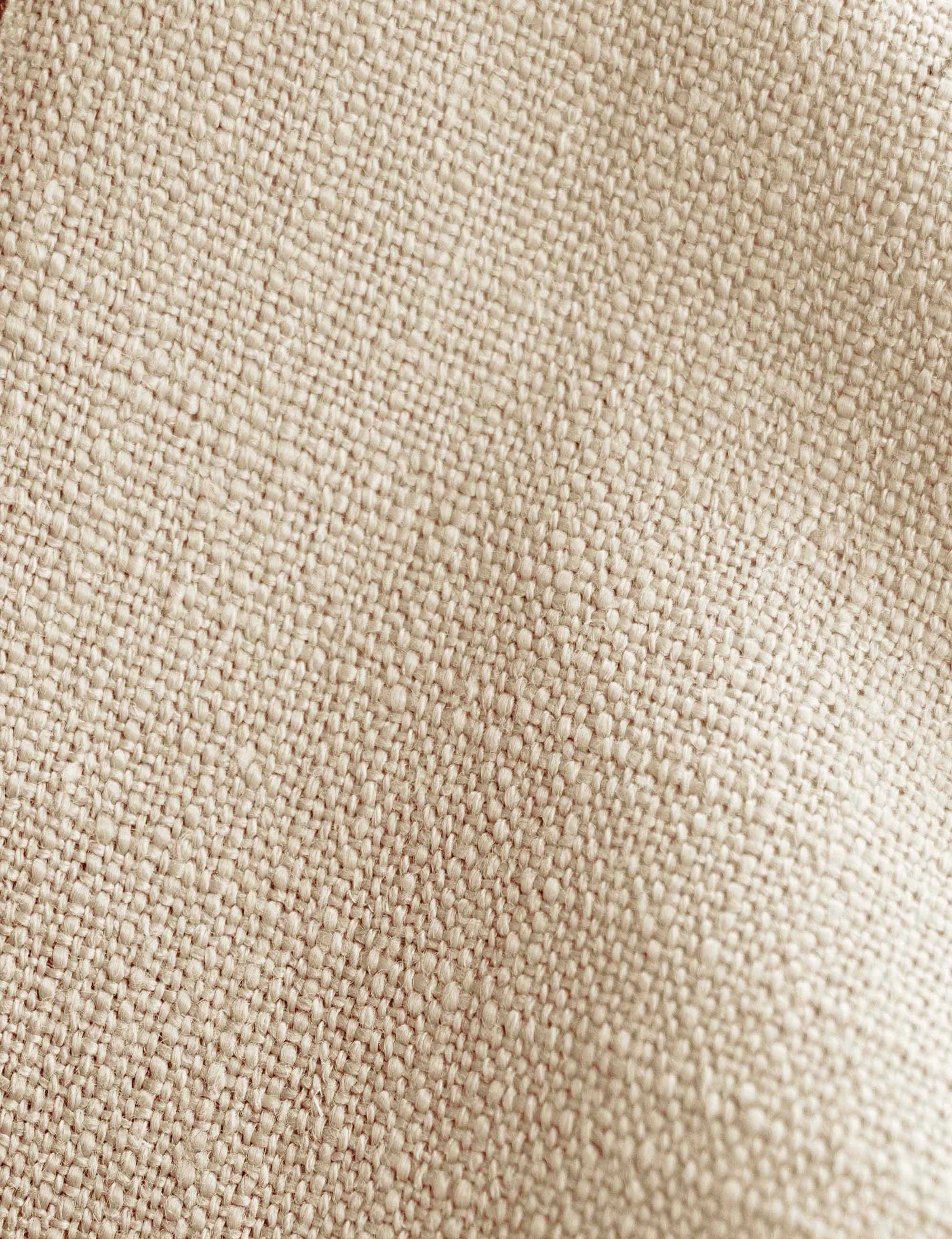 Detailed shot of the natural linen on the Adara natural linen upholstered bed.