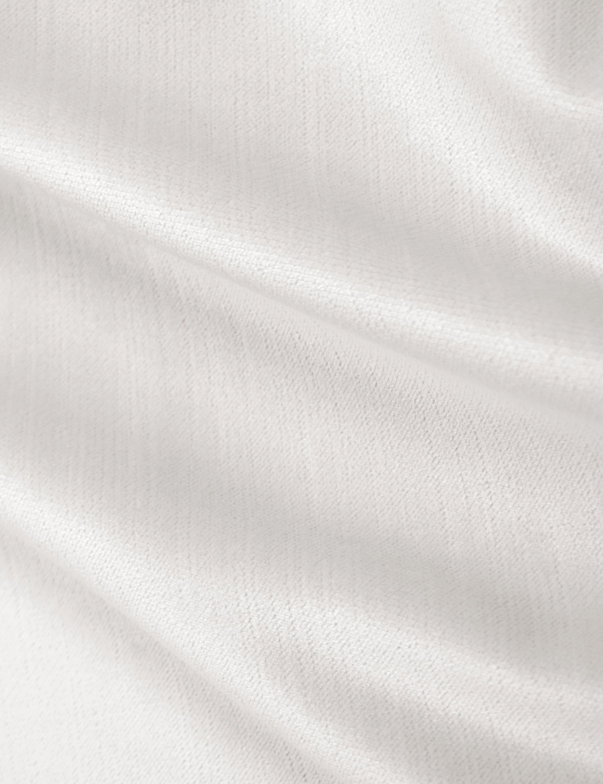 Detailed shot of the white velvet on the Adara white velvet upholstered bed.