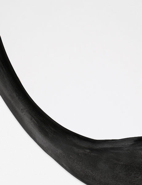 #color::black | Close-up of the inorganic frame design on the Doreen black organic round mirror
