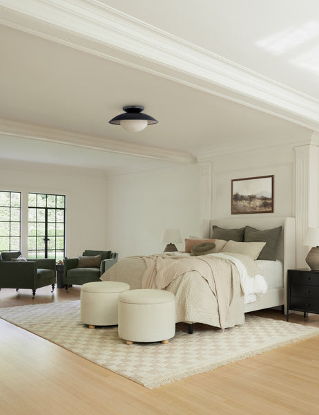 #showall::39648321994851 | Two Kamila White Boucle 24-inch ottomans sit at the end of a ivory linen framed bed with olive linens atop a checkerboard rug