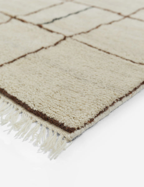 color::ivory #size::6--x-9- #size::8--x-10- #size::9--x-12- #size::10--x-14- #size::12--x-15- | Tasseled ends on the corner of the Irregular Grid Rug by Sarah Sherman Samuel