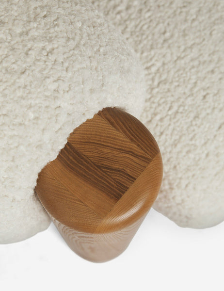 | Bird's-eye view of the wooden leg on the top of the James faux sherpa accent chair