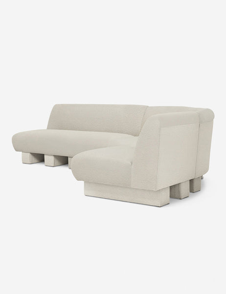 #color::Ivory-Boucle #configuration::right-facing #size::114-W | Angled view of the Lena right-facing white boucle sectional sofa with upholstered beam legs.